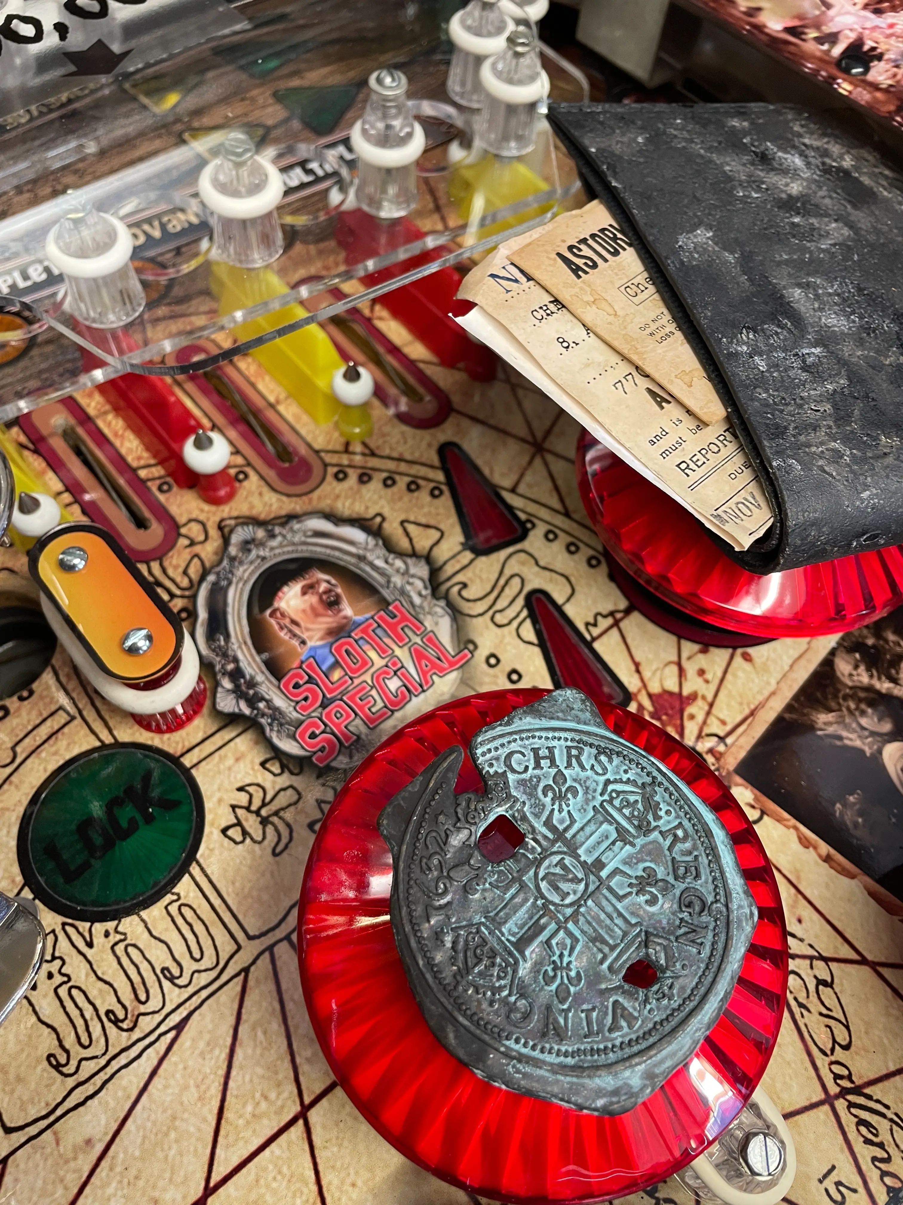 Vintage pinball machine with ornate coin and game details close-up