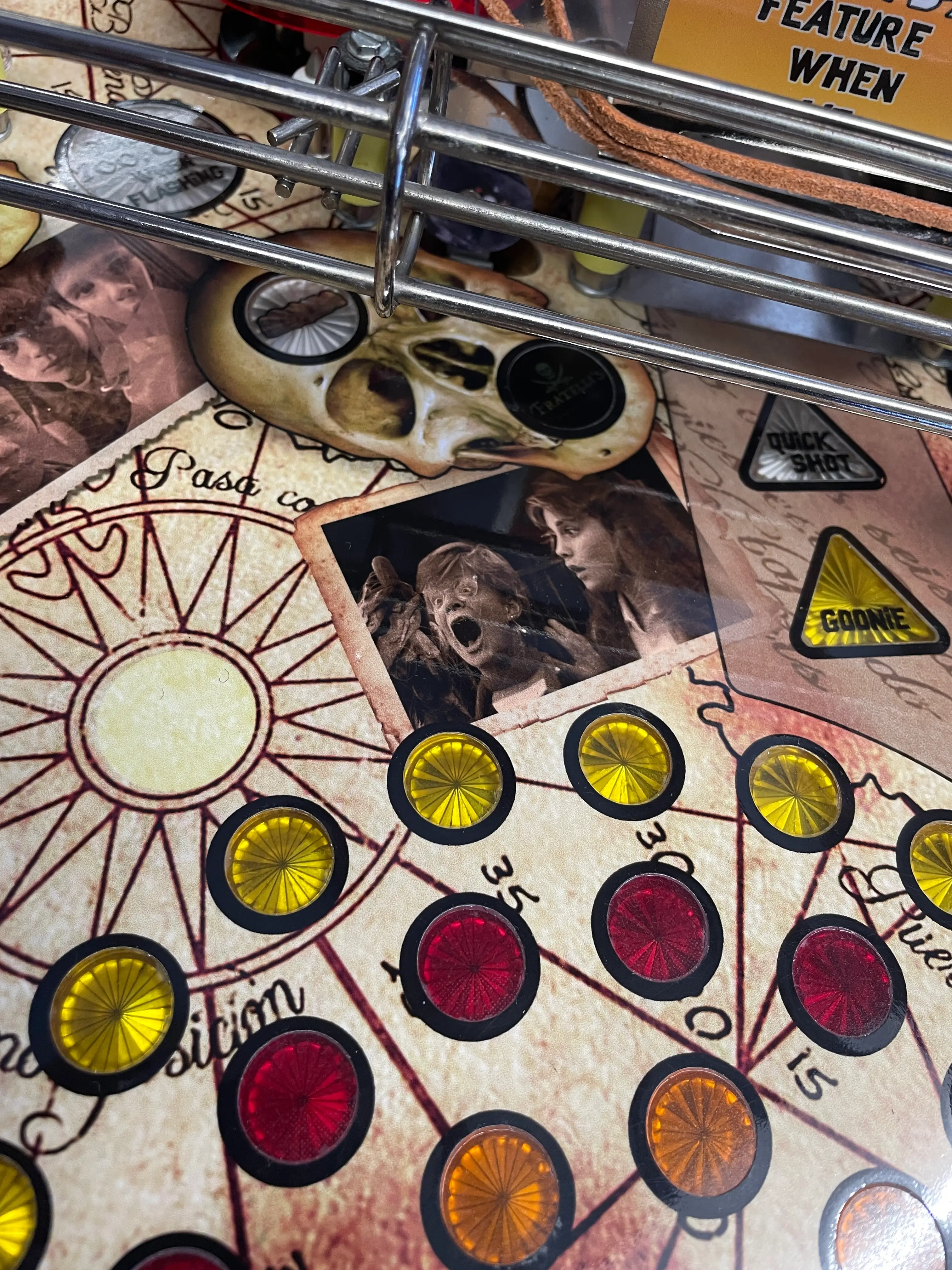 Vintage game board with colored tokens, skull, and old photographs