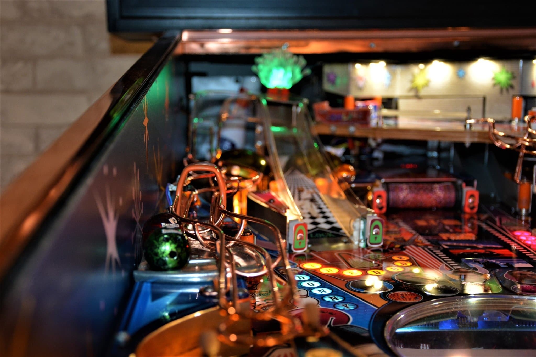 Colorful pinball machine with illuminated buttons and metallic components