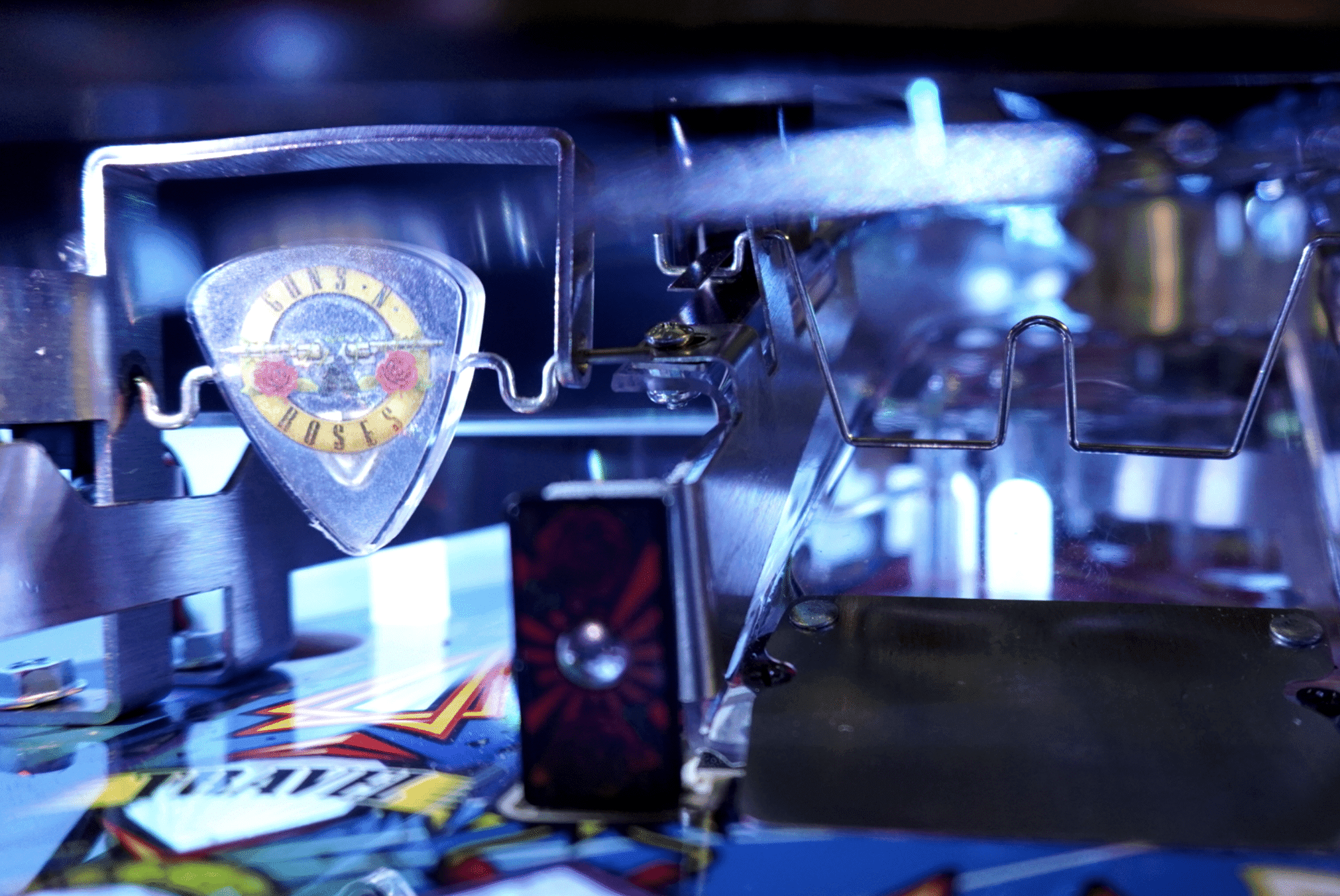 Guns N' Roses guitar pick in clear holder with blurred blue background