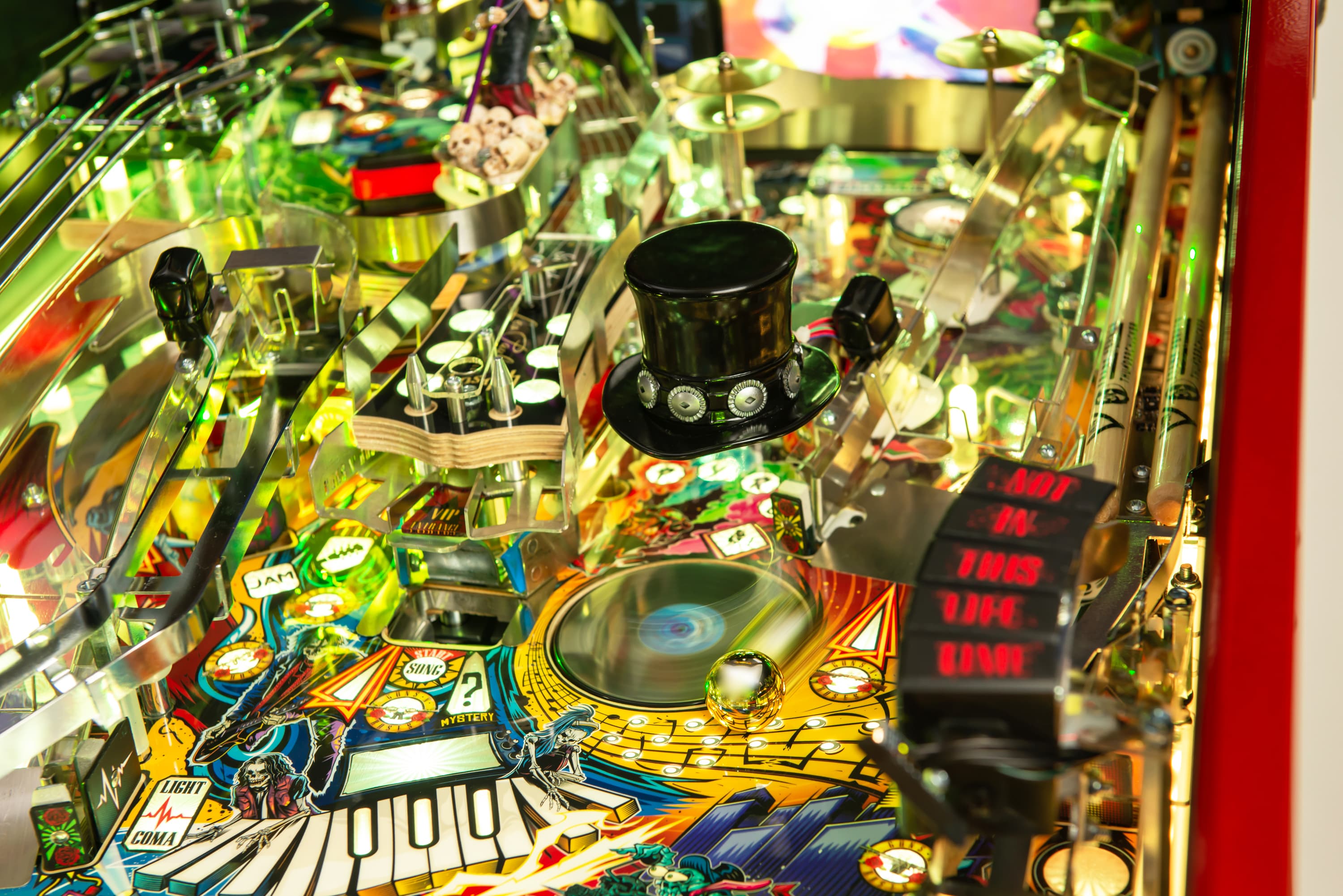 Colorful pinball machine with top hat, musical and gaming elements