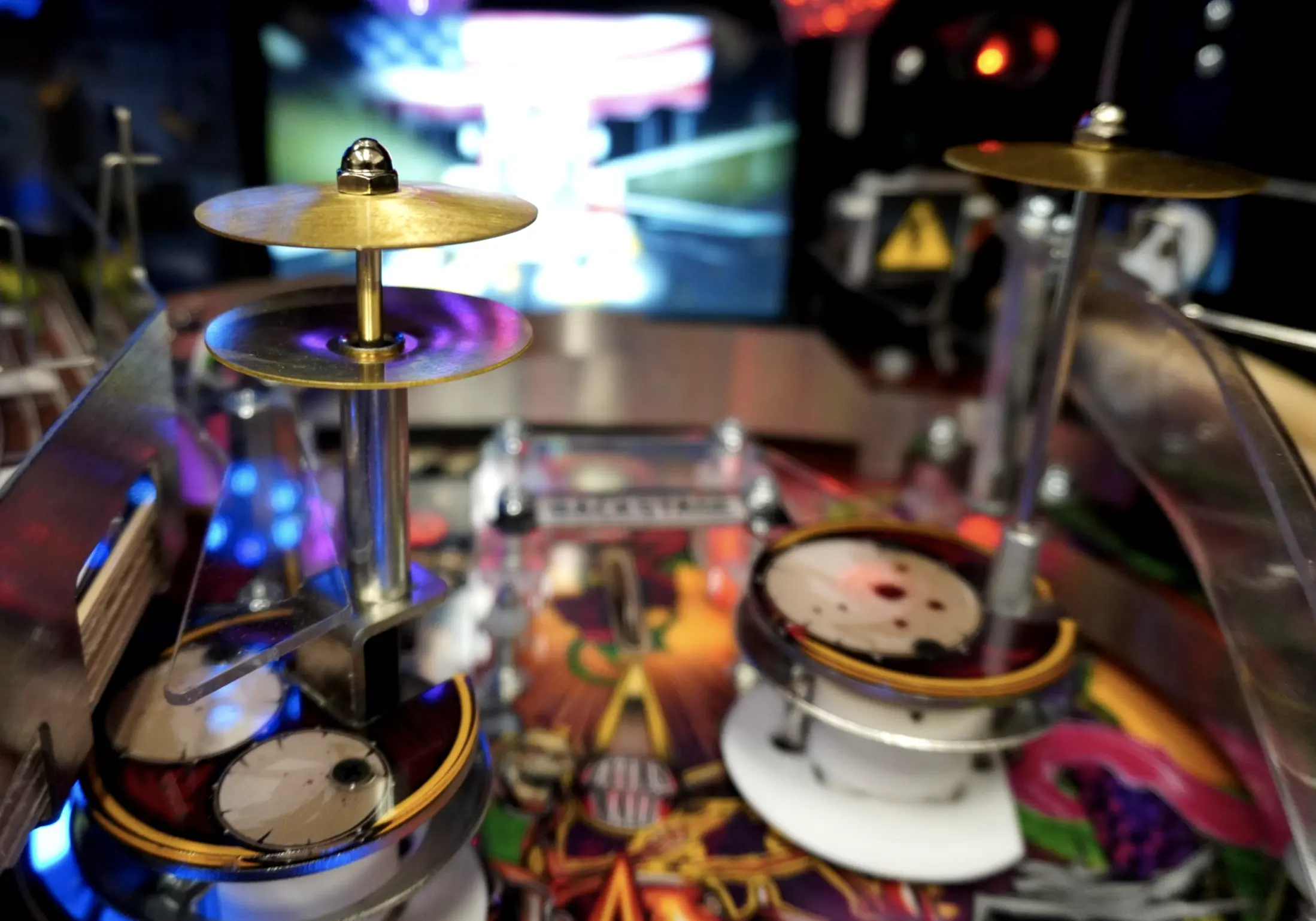 Miniature cymbal drums with colorful lights in background