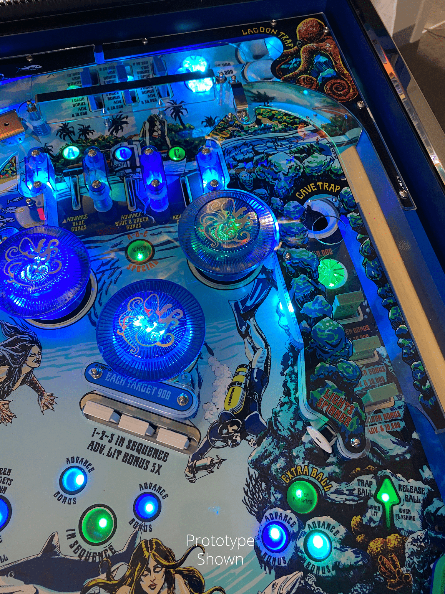 Underwater-themed pinball machine with blue and green illuminated targets