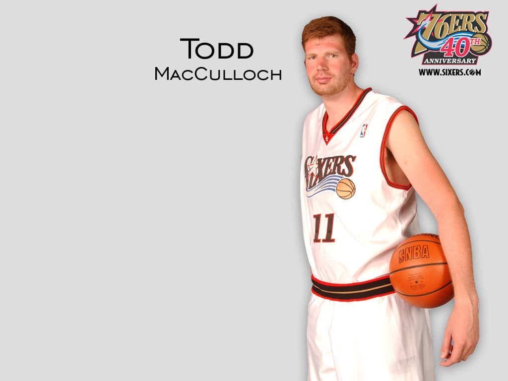 Todd MacCulloch in Philadelphia 76ers jersey holding basketball