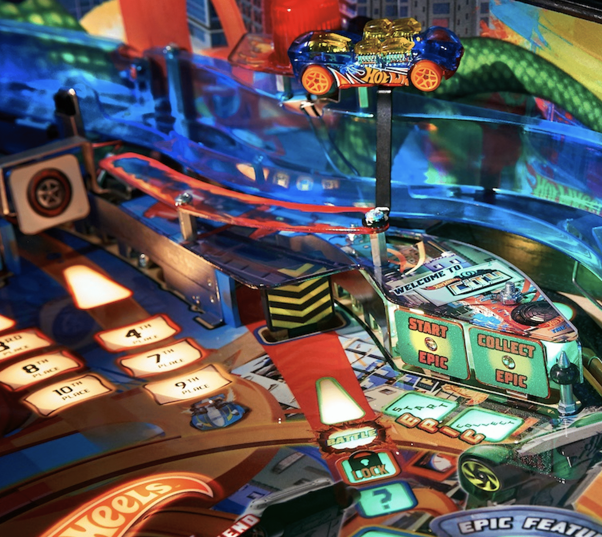 Colorful Hot Wheels pinball machine with cars, tracks, and game elements