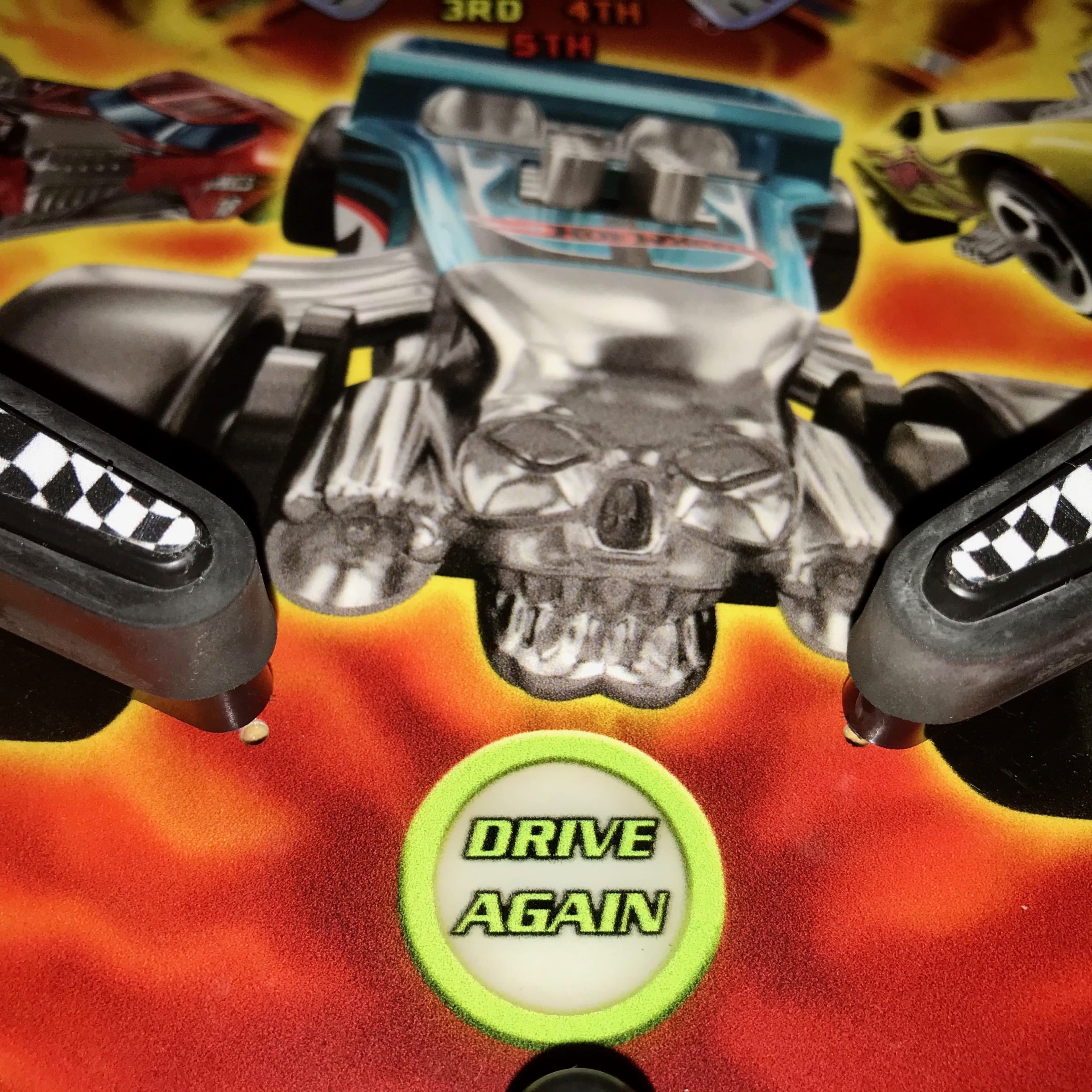 Skull-themed racing game controller with "Drive Again" button