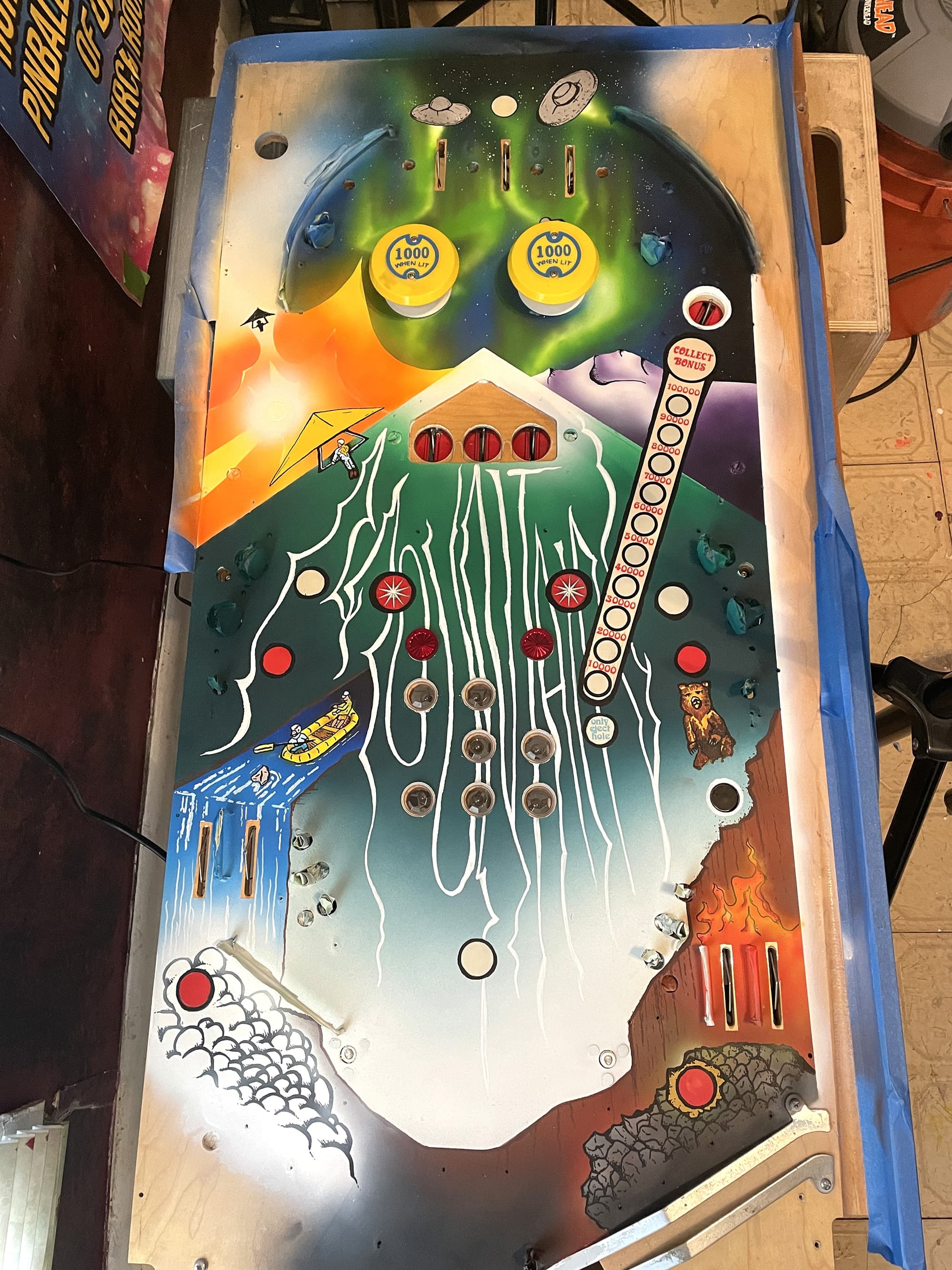 Vintage space-themed pinball machine playfield with colorful graphic design