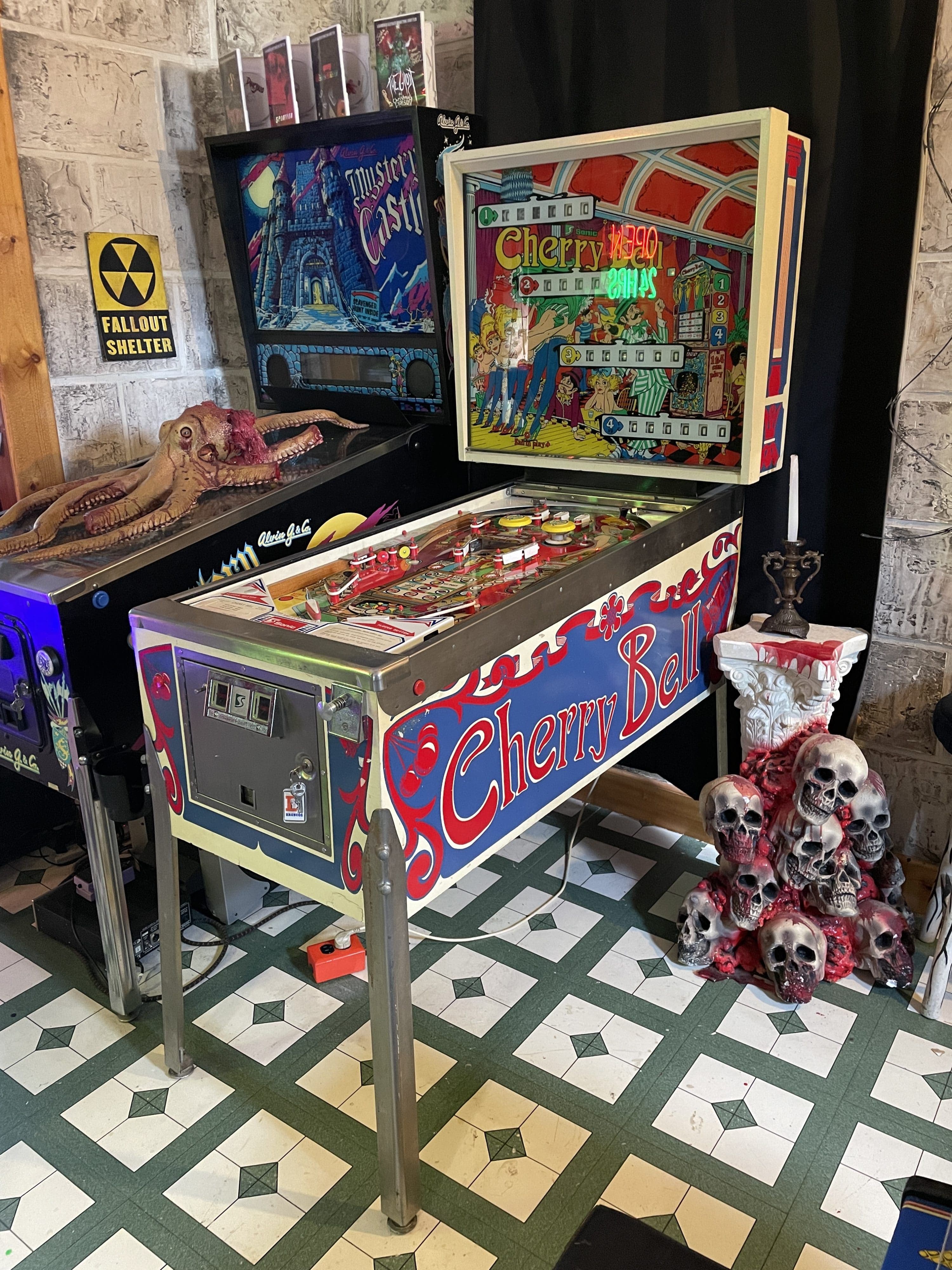 Vintage Cherry Bell pinball machine with spooky skulls and fallout shelter sign