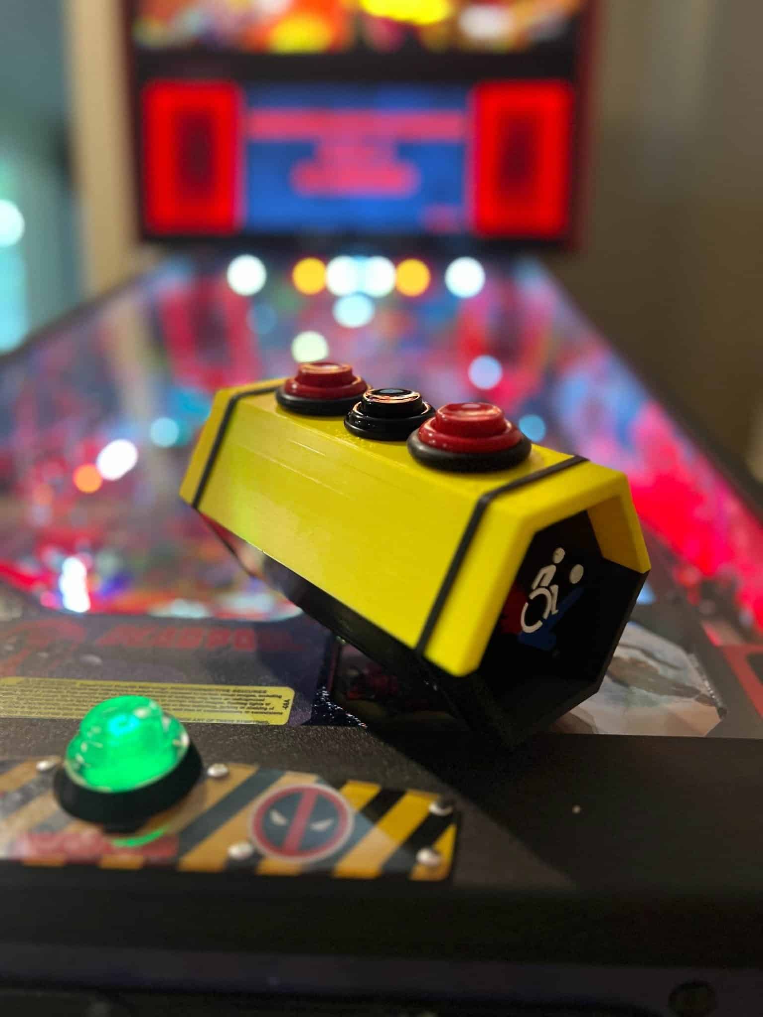 Yellow arcade control panel with red buttons and blurry colorful background