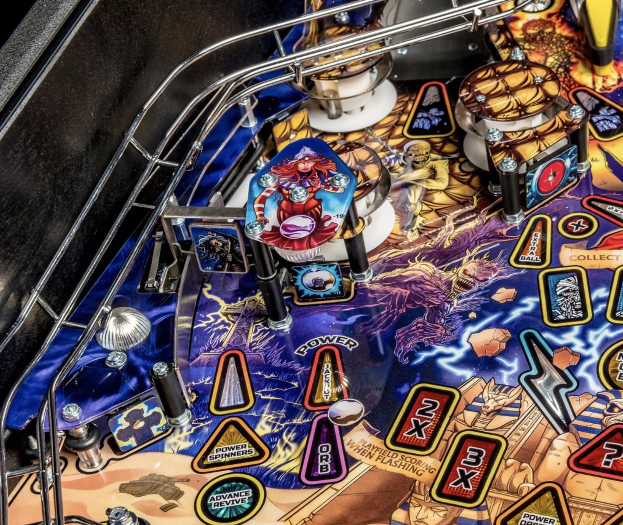 Colorful pinball machine with fantasy-themed artwork and intricate playfield details