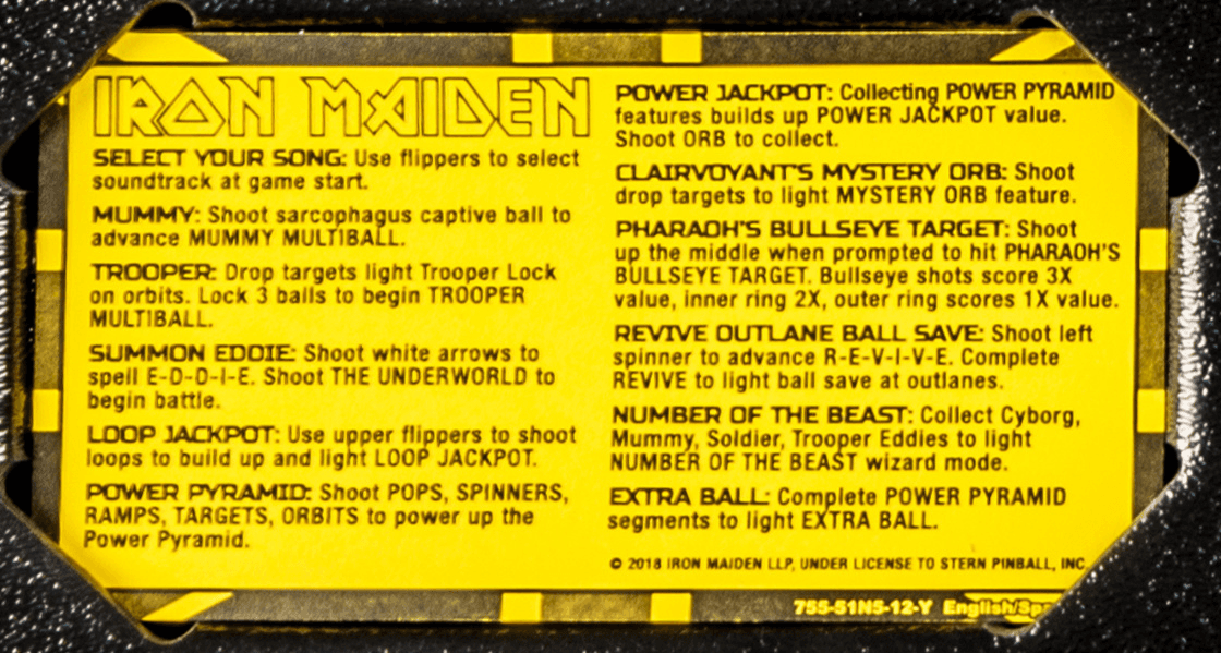 Iron Maiden pinball game instruction card with yellow and black design