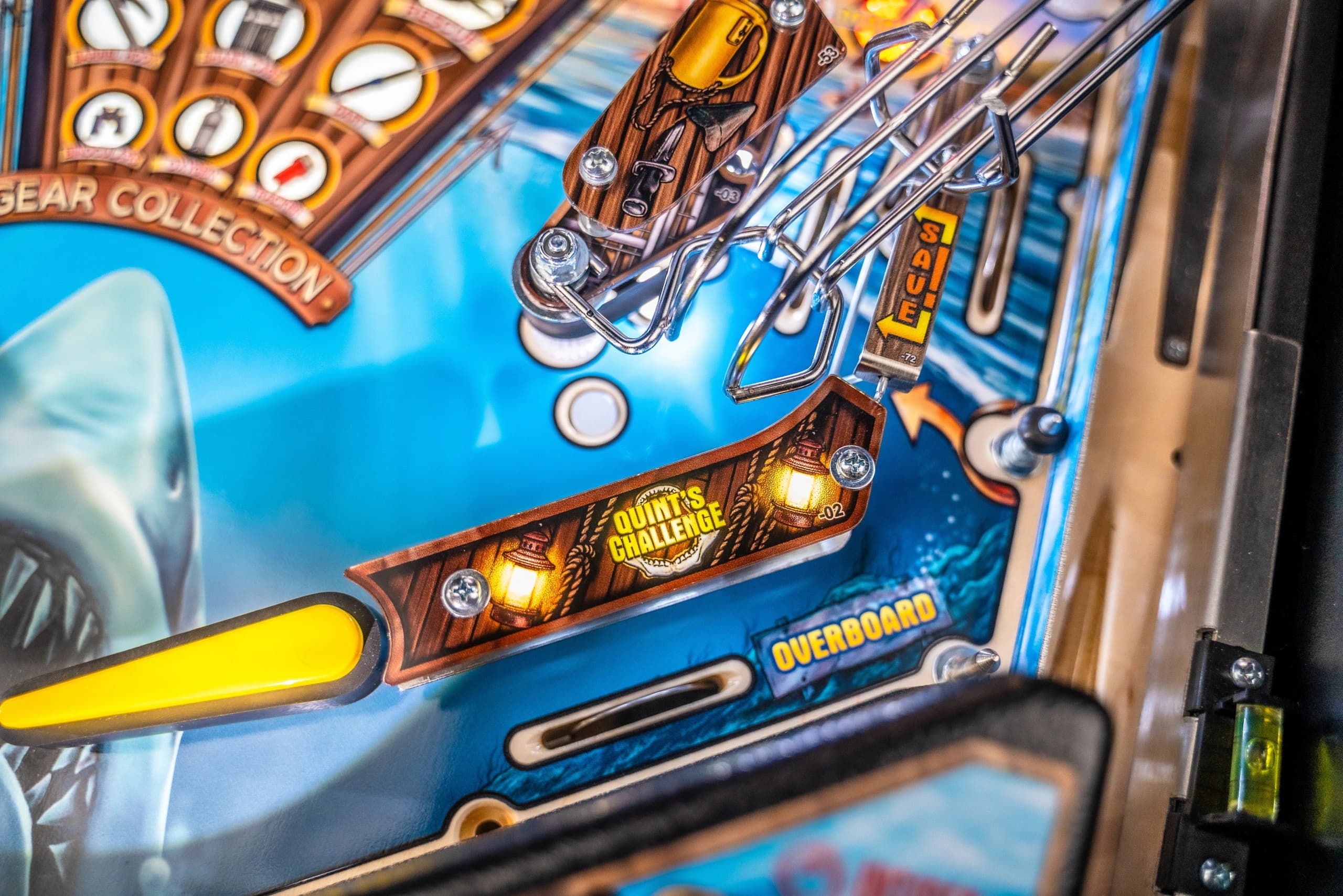Close-up of pinball machine with Overboard and Quinn's Challenge signs