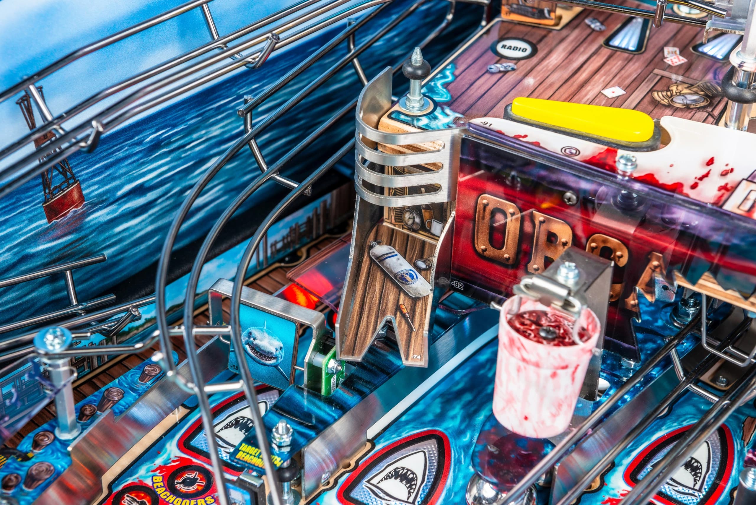 Detailed close-up of a shark-themed pinball machine with metallic elements