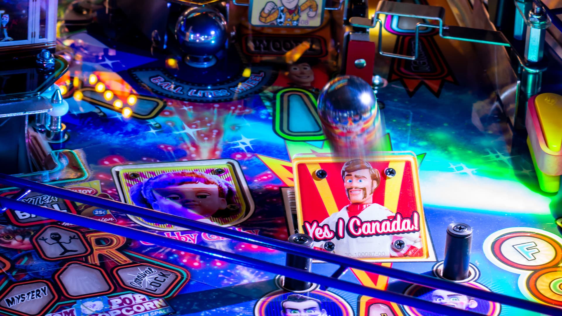 Colorful pinball machine with cartoon characters and vibrant lighting
