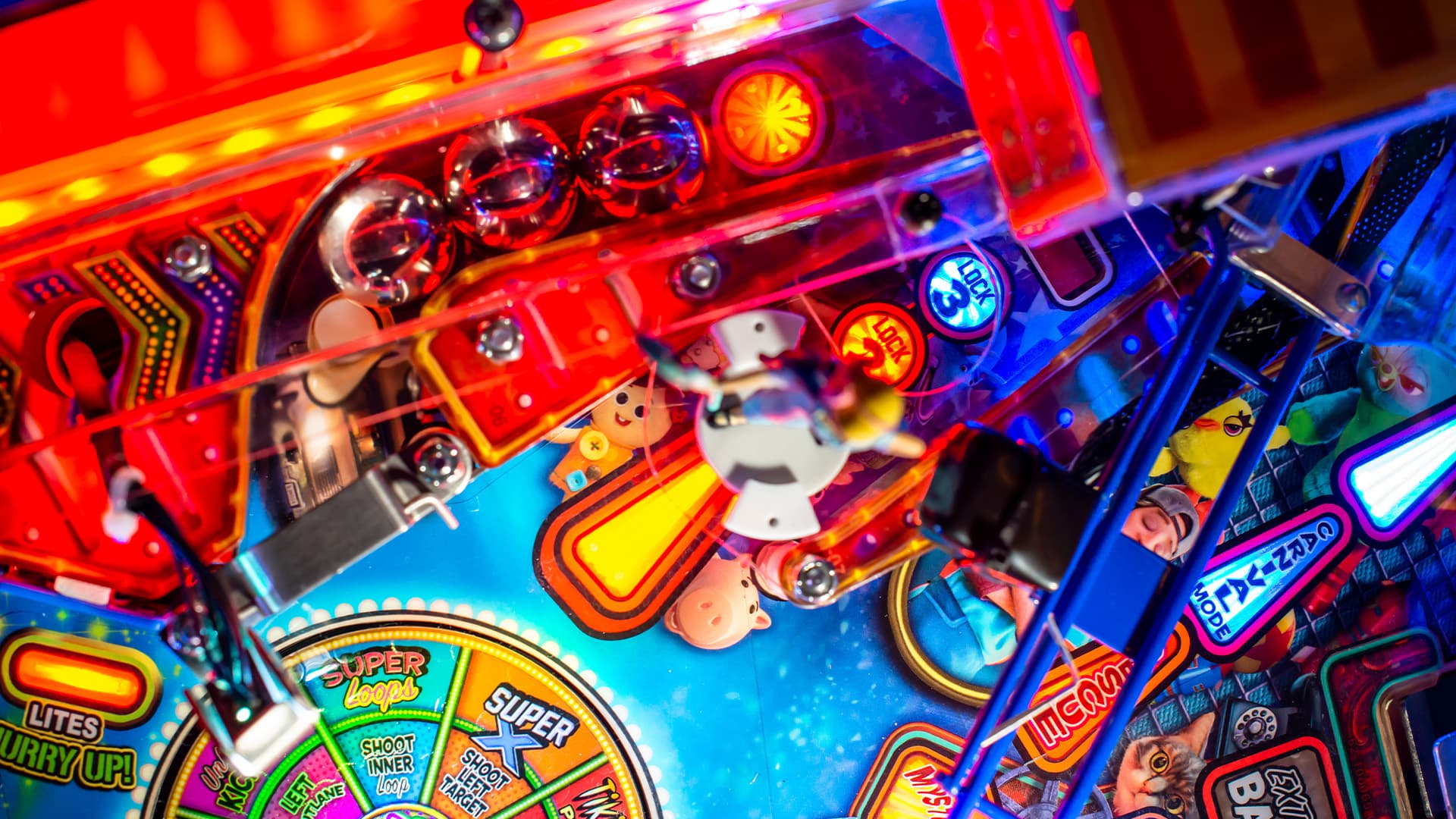 Colorful pinball machine with vibrant lights, buttons, and playful design