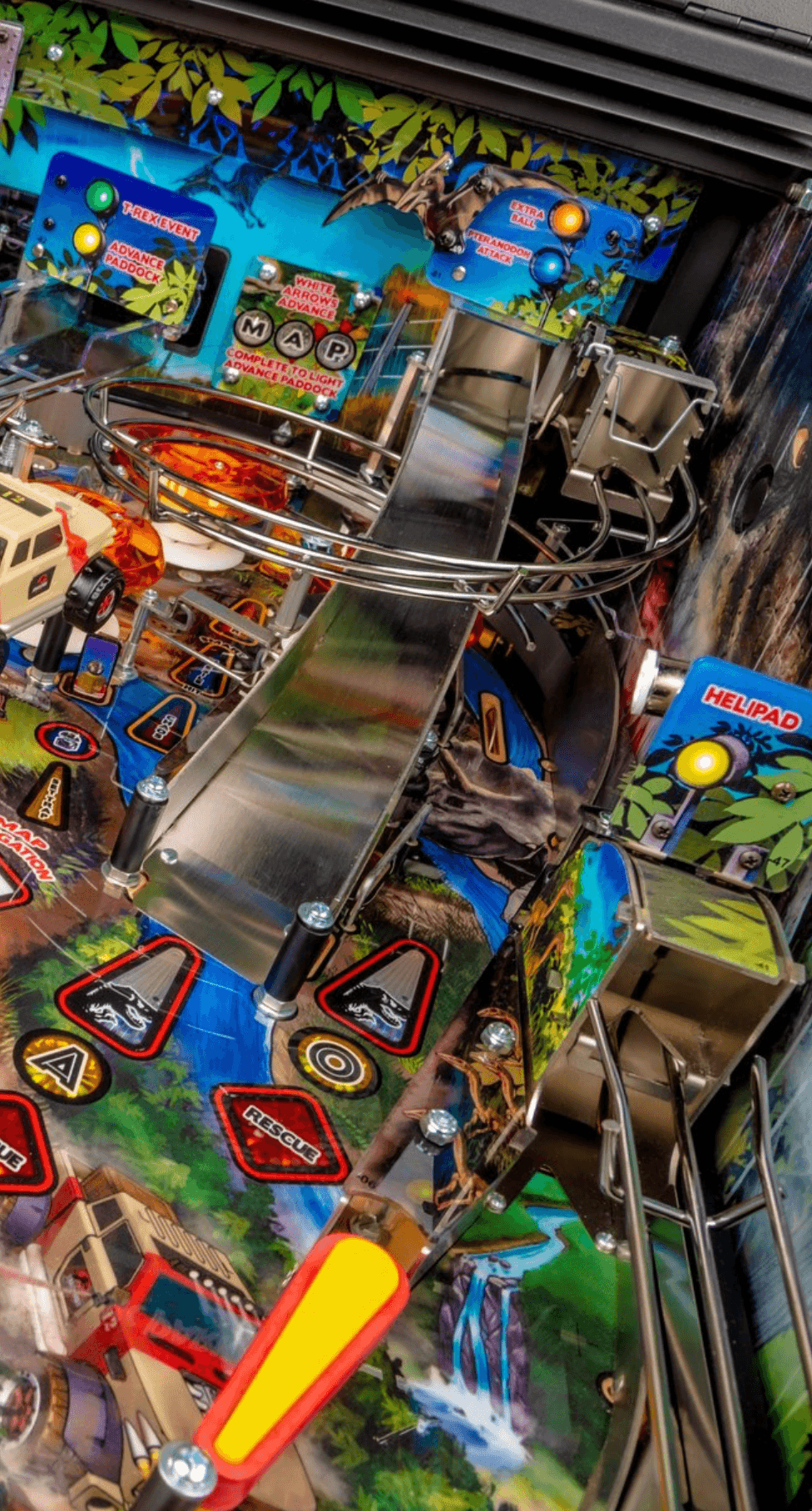 Colorful pinball machine with jungle theme and mechanical components