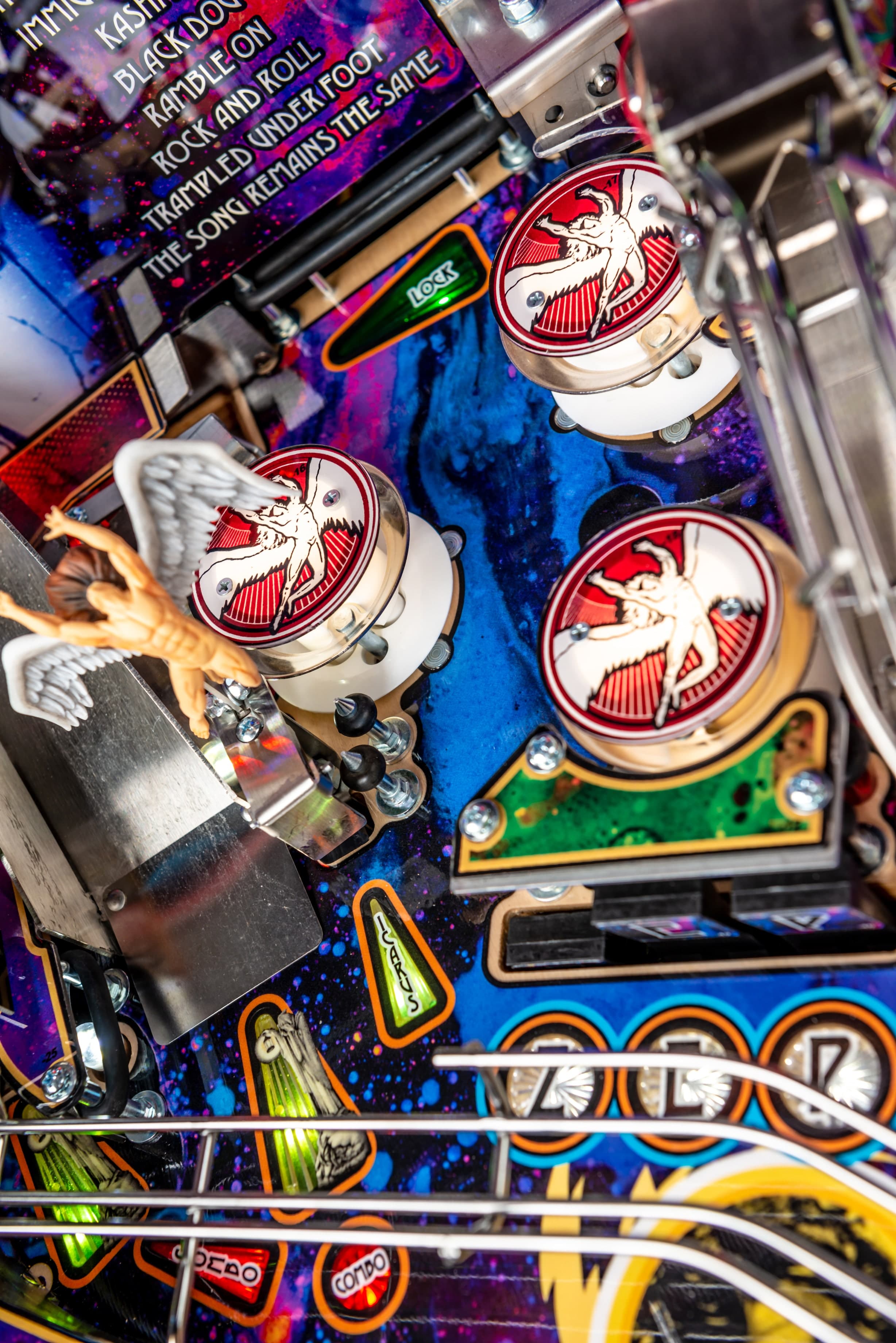 Colorful pinball machine interior with mechanical components and graphic details