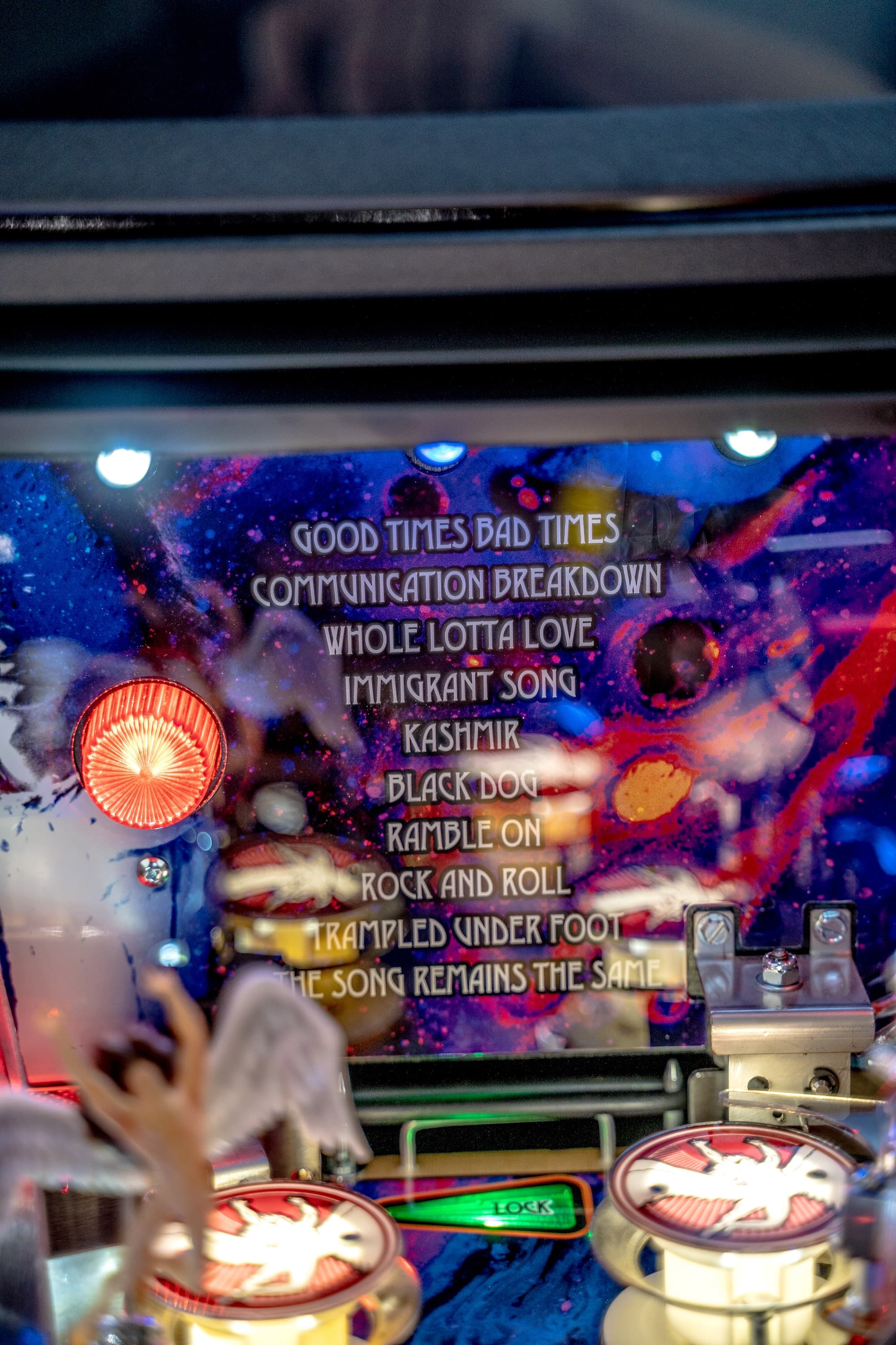 Led Zeppelin pinball machine with colorful cosmic background and song titles