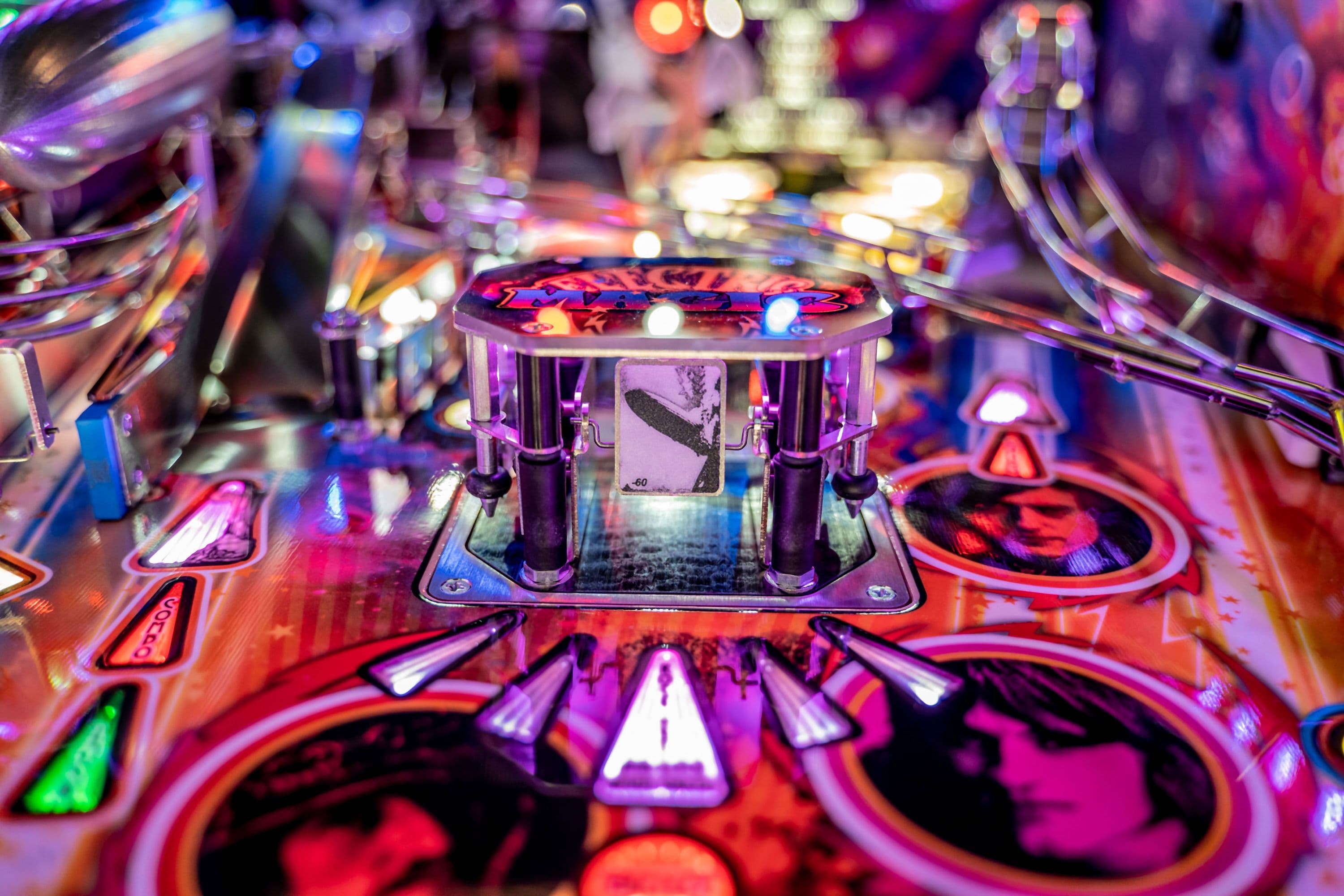 Colorful pinball machine close-up with vibrant lights and detailed game board