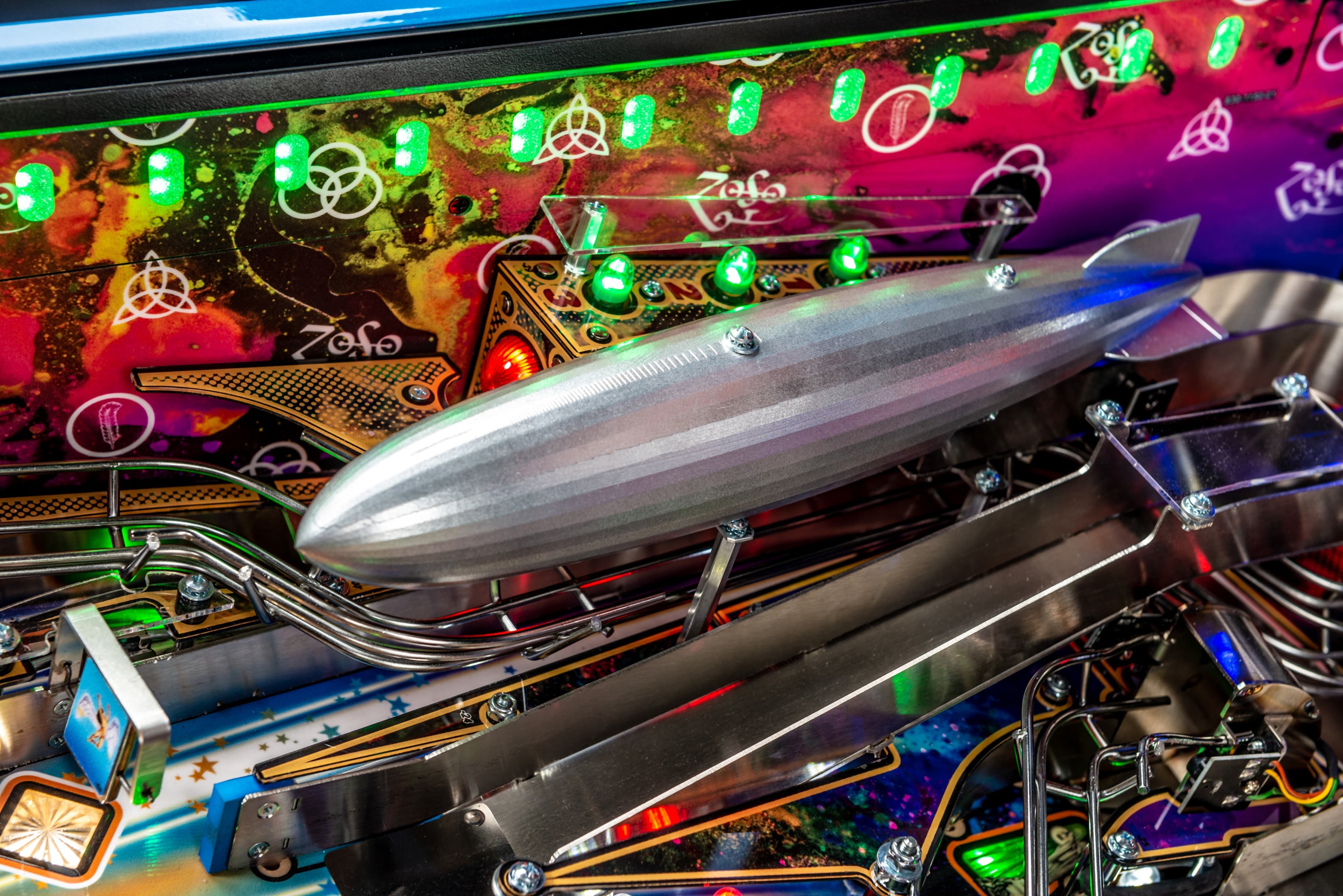 Shiny zeppelin pinball machine detail with colorful lights and metallic parts