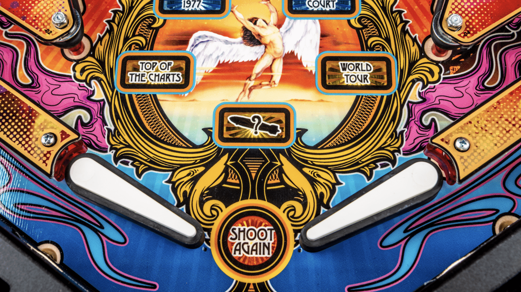 Colorful vintage pinball machine with winged angel and game labels