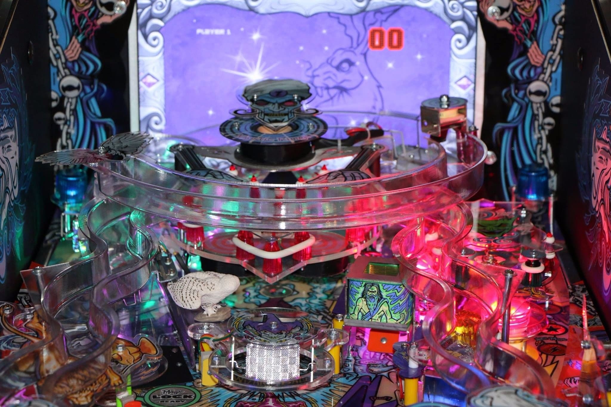 Colorful pinball machine with complex transparent ramps and vibrant backlight