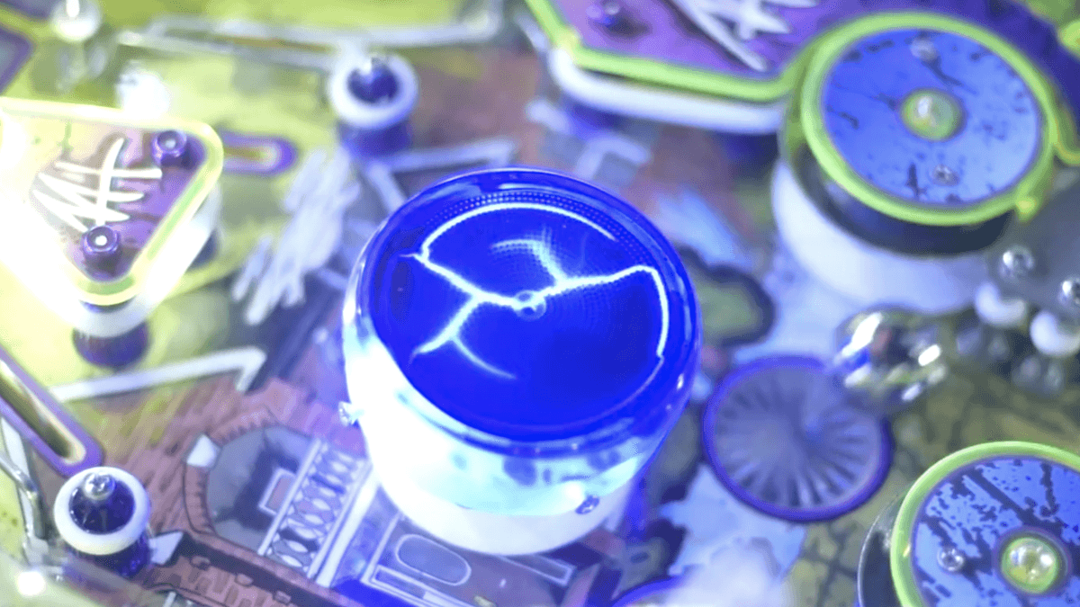 Glowing blue electronic component on circuit board with blurred components