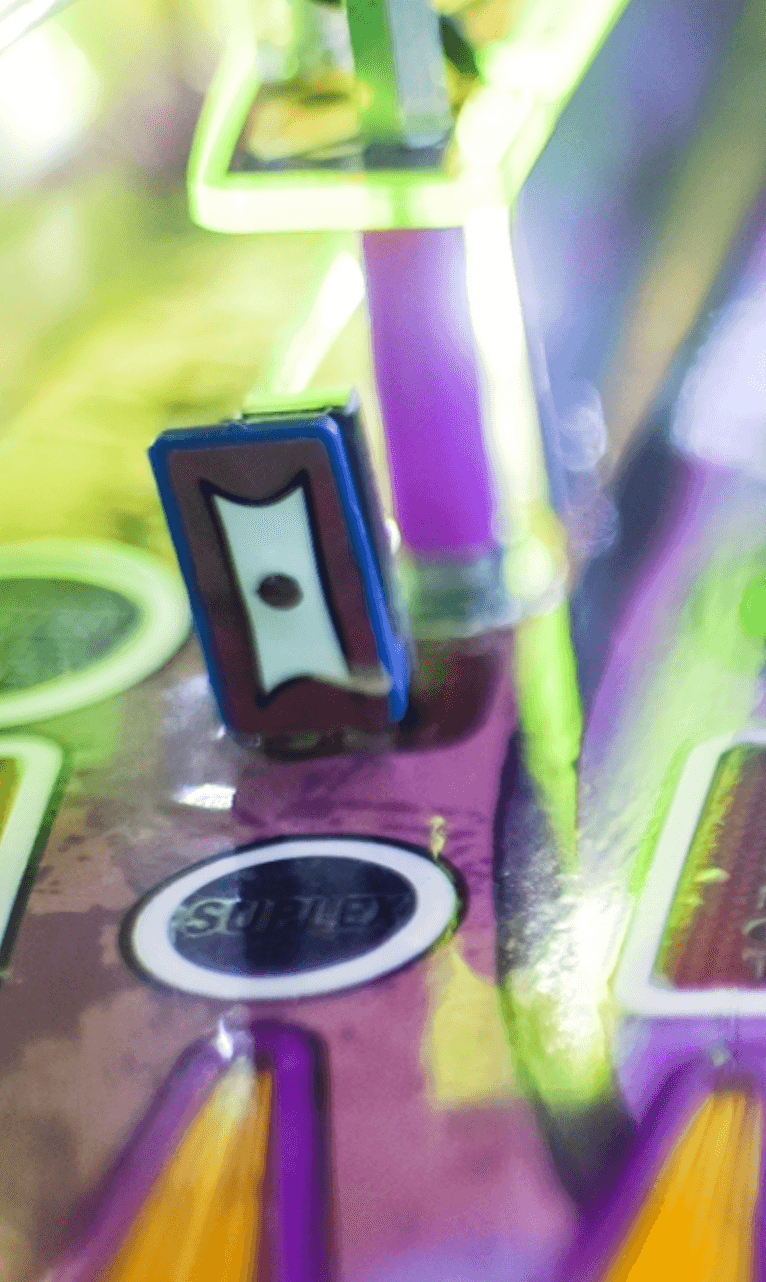 Blurry pencil sharpener on a colorful purple and green background