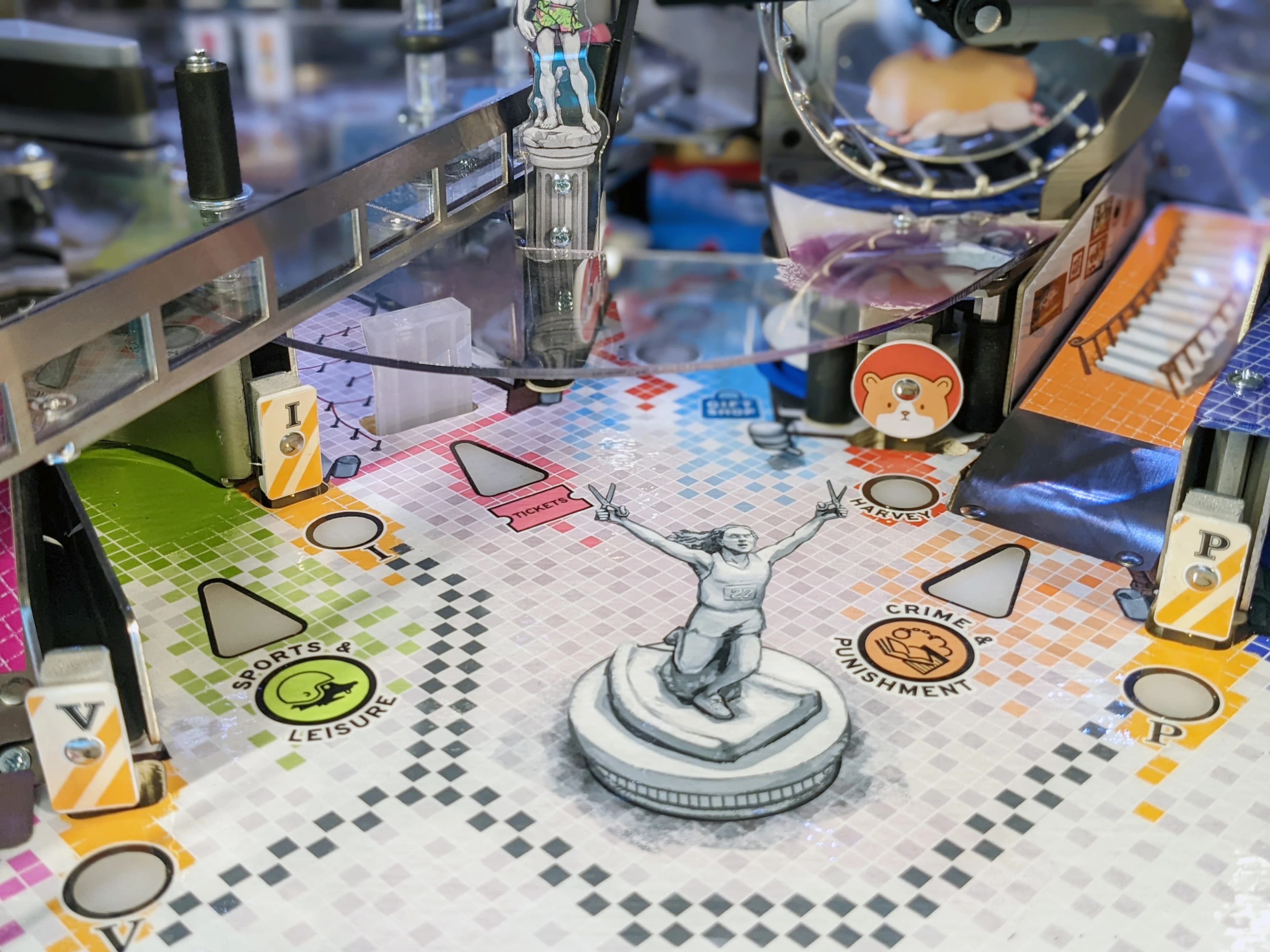 Board game with statue, colorful grid, and mechanical equipment