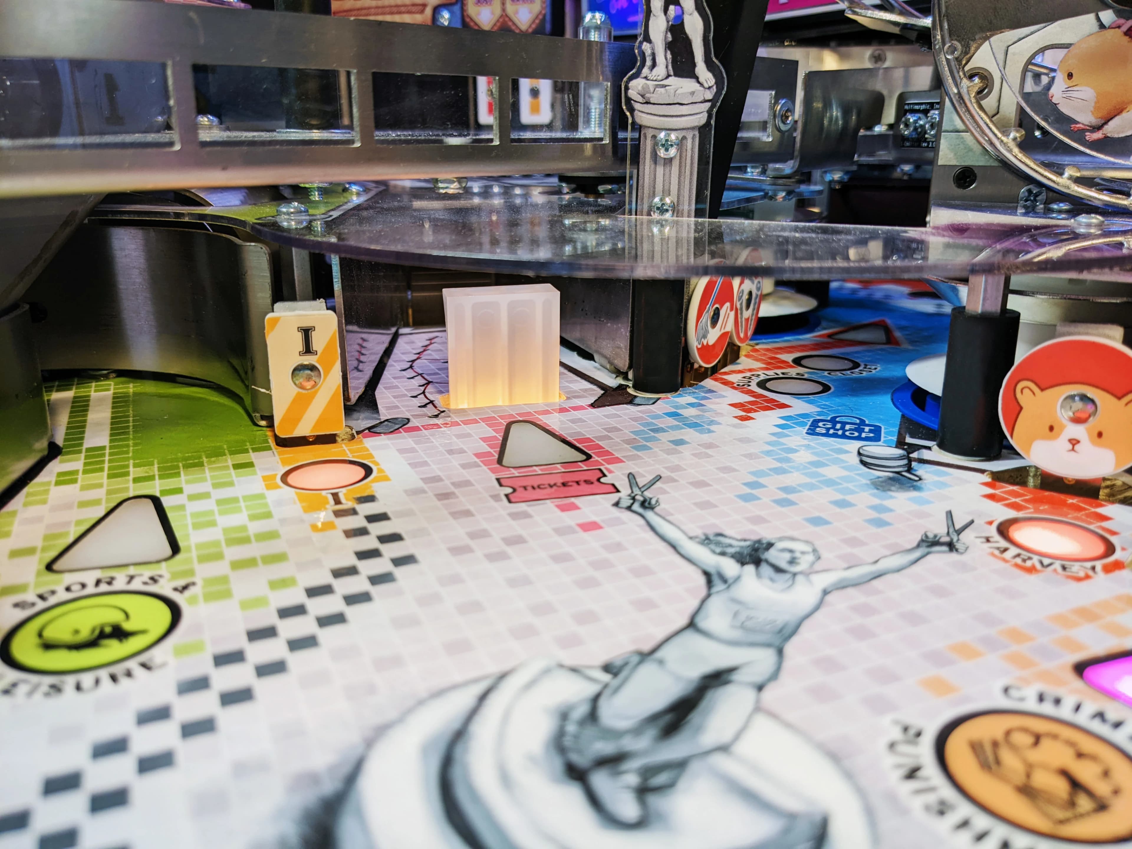 Detailed pinball machine playfield with colorful graphics and mechanical components