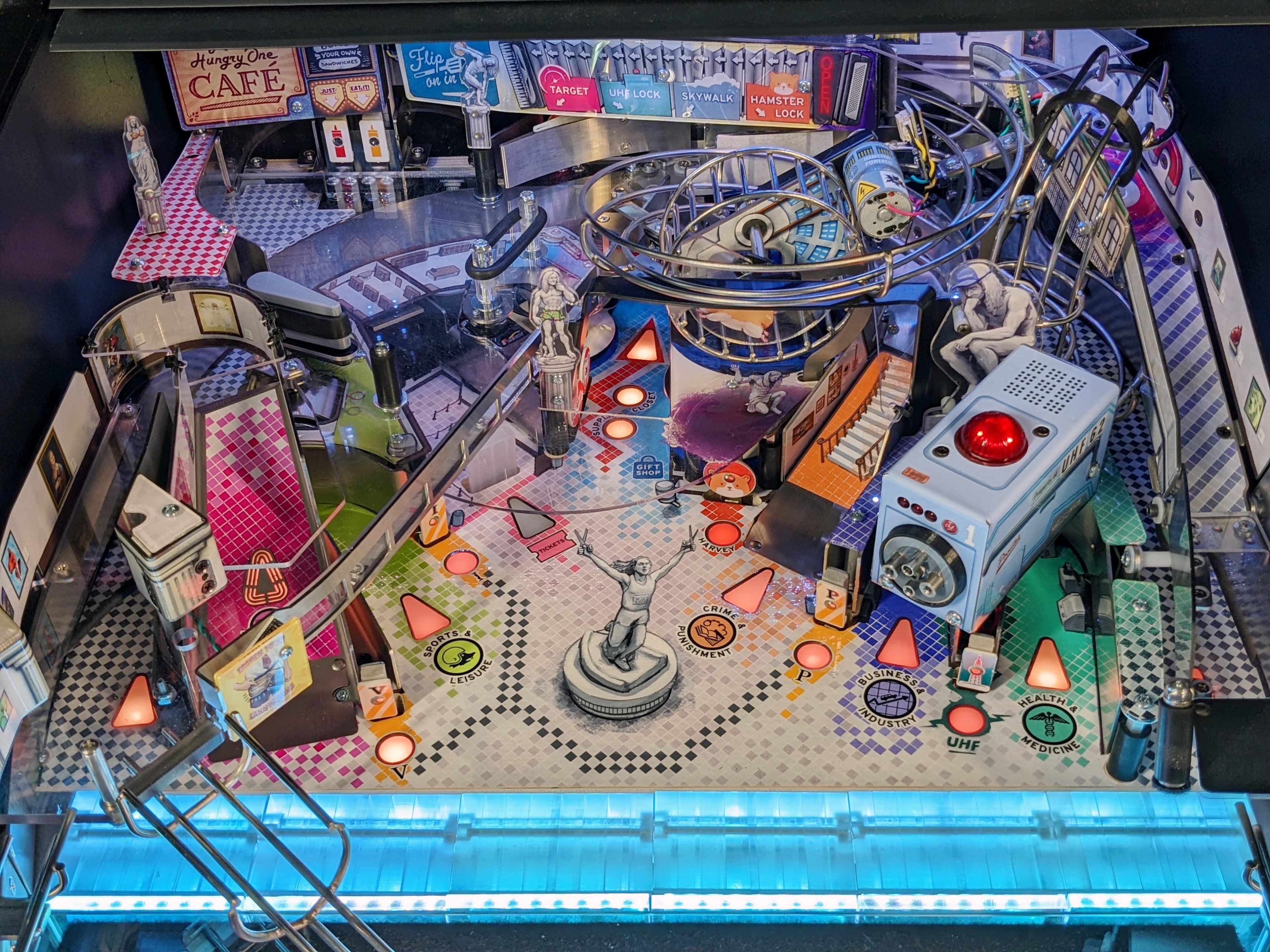 Intricate pinball machine with complex urban-themed layout and colorful zones