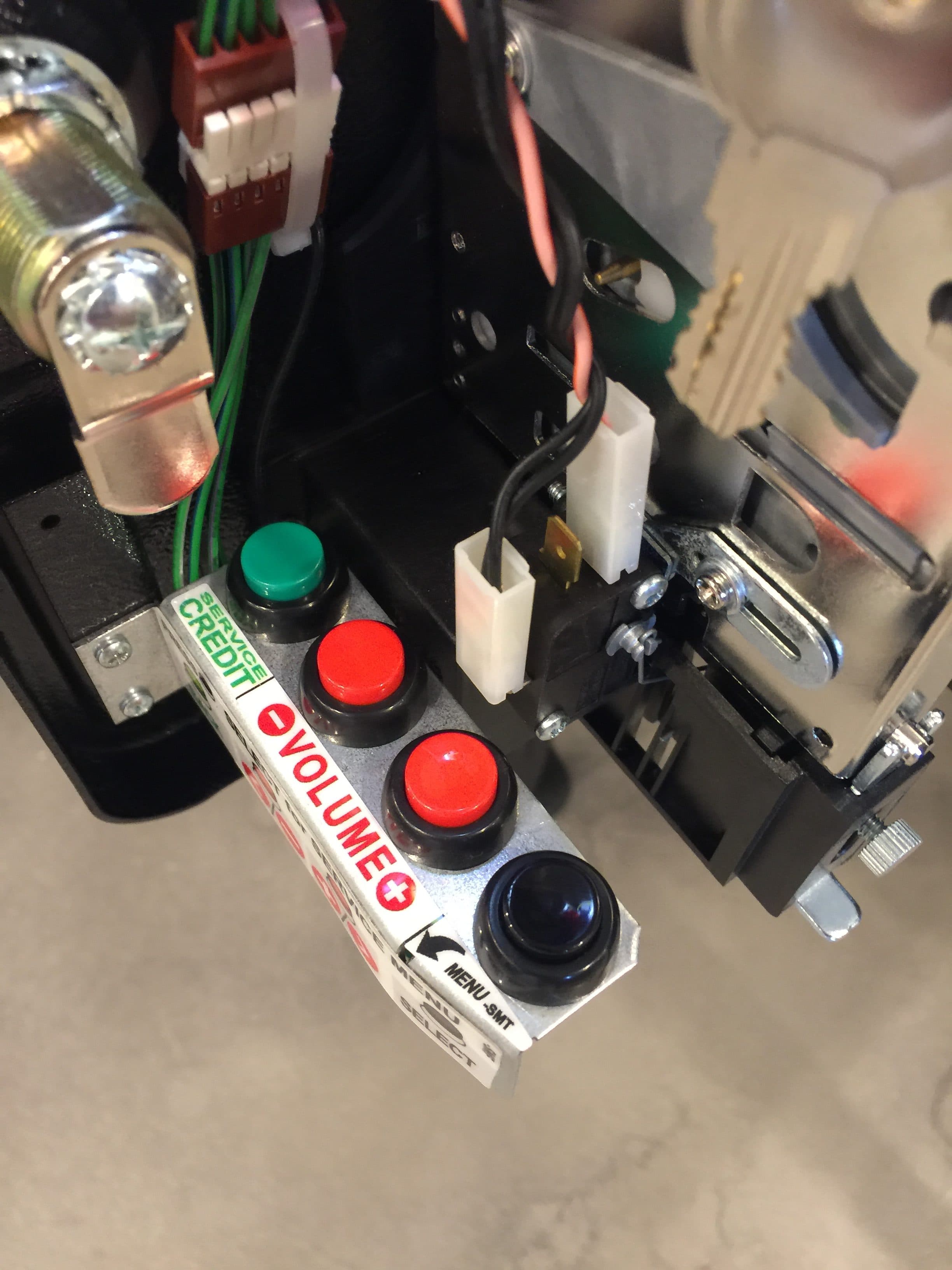 Control panel with red, green, and black buttons on electronic device