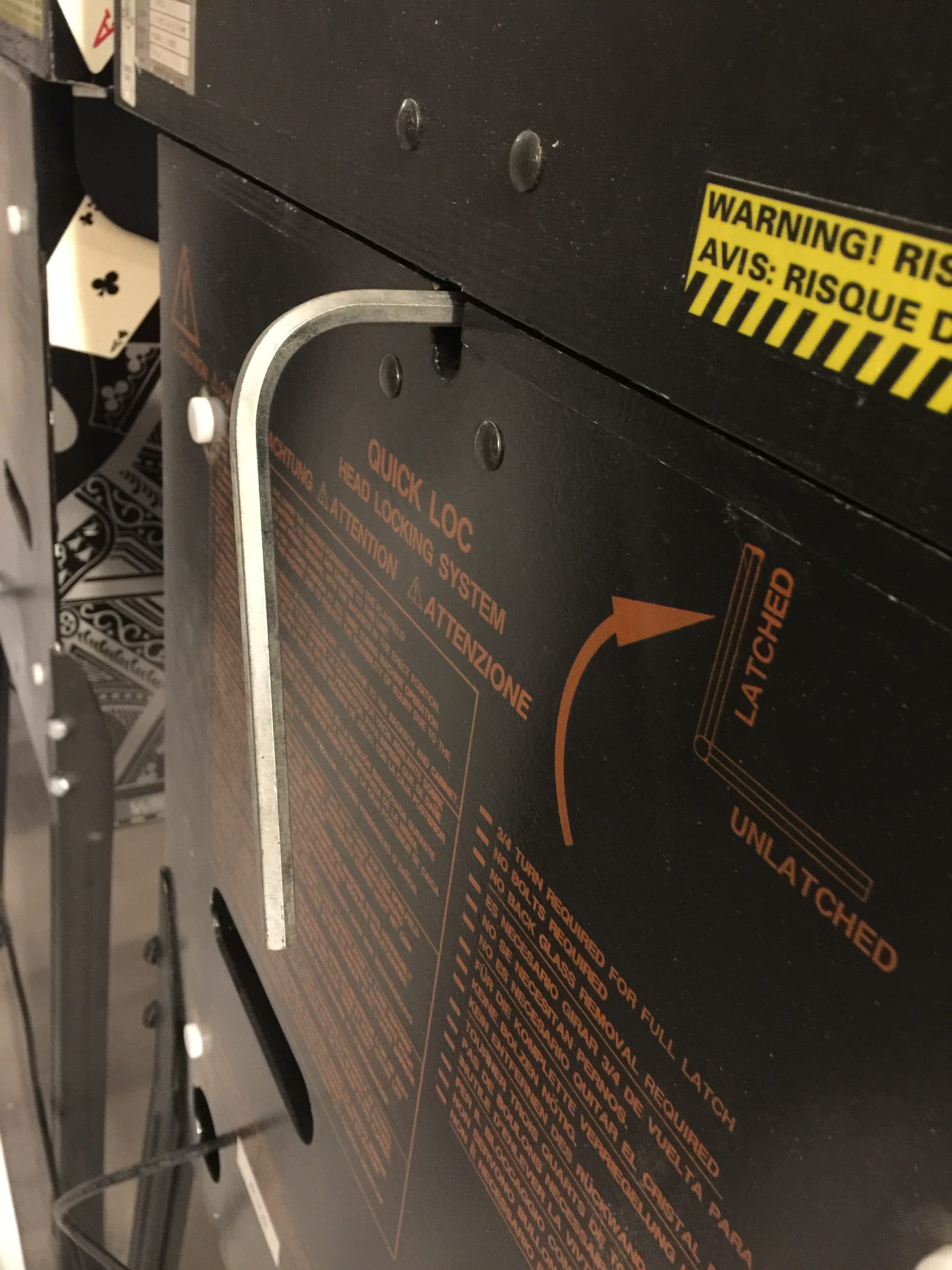 Warning label on industrial equipment with quick lock system and safety instructions
