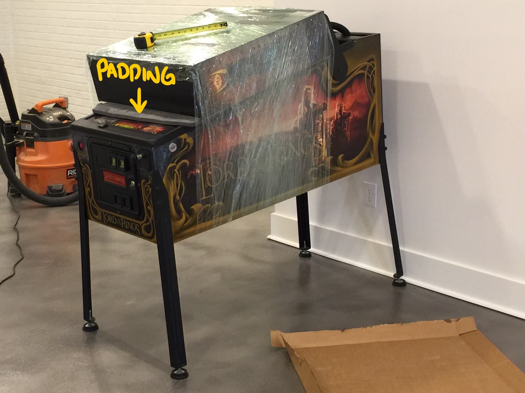 Lord of the Rings pinball machine with yellow padding arrow and tape measure