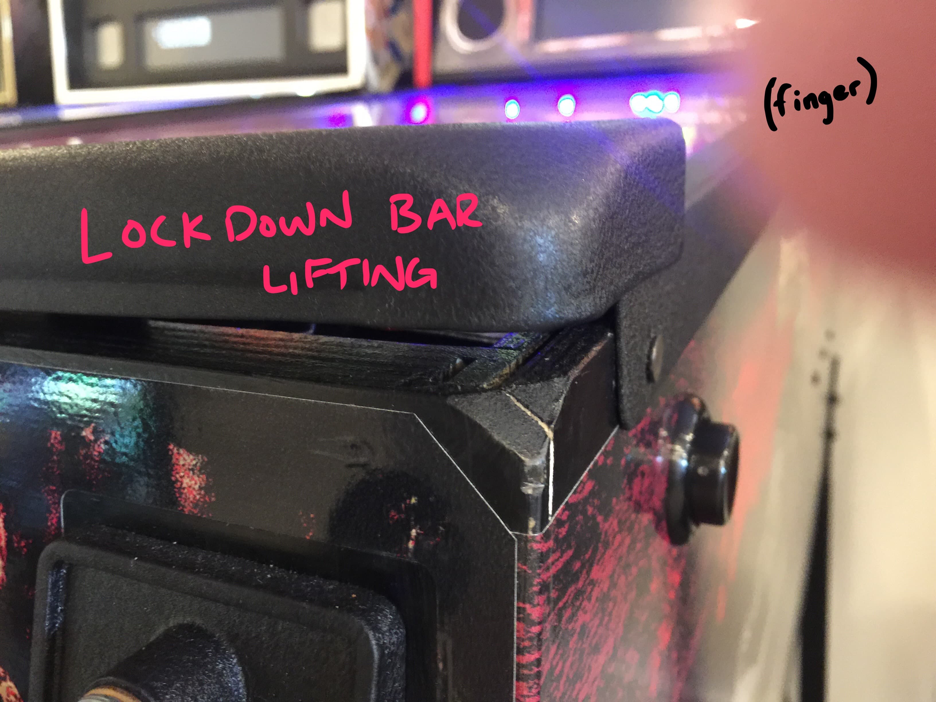 Close-up of gym equipment with "Lock Down Bar Lifting" handwritten in pink