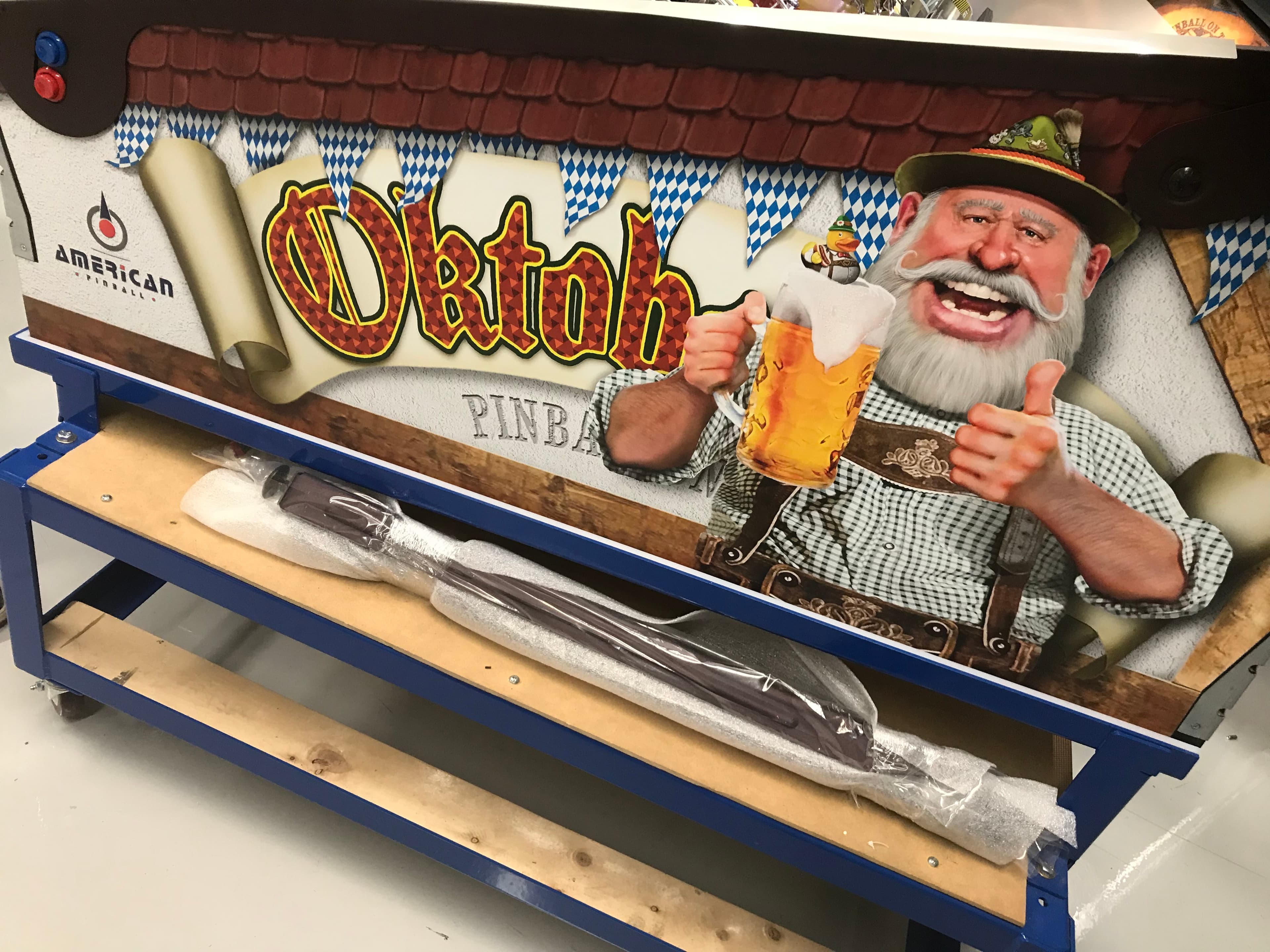 Oktoberfest-themed pinball machine with Bavarian man holding beer