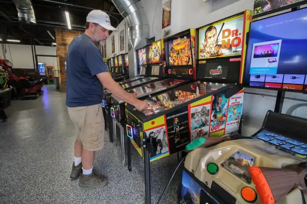 Man with a beard about to play James Bond Dr. No Pinball