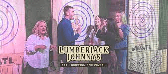 People at Lumberjack Johnnys axe throwing venue with target backgrounds