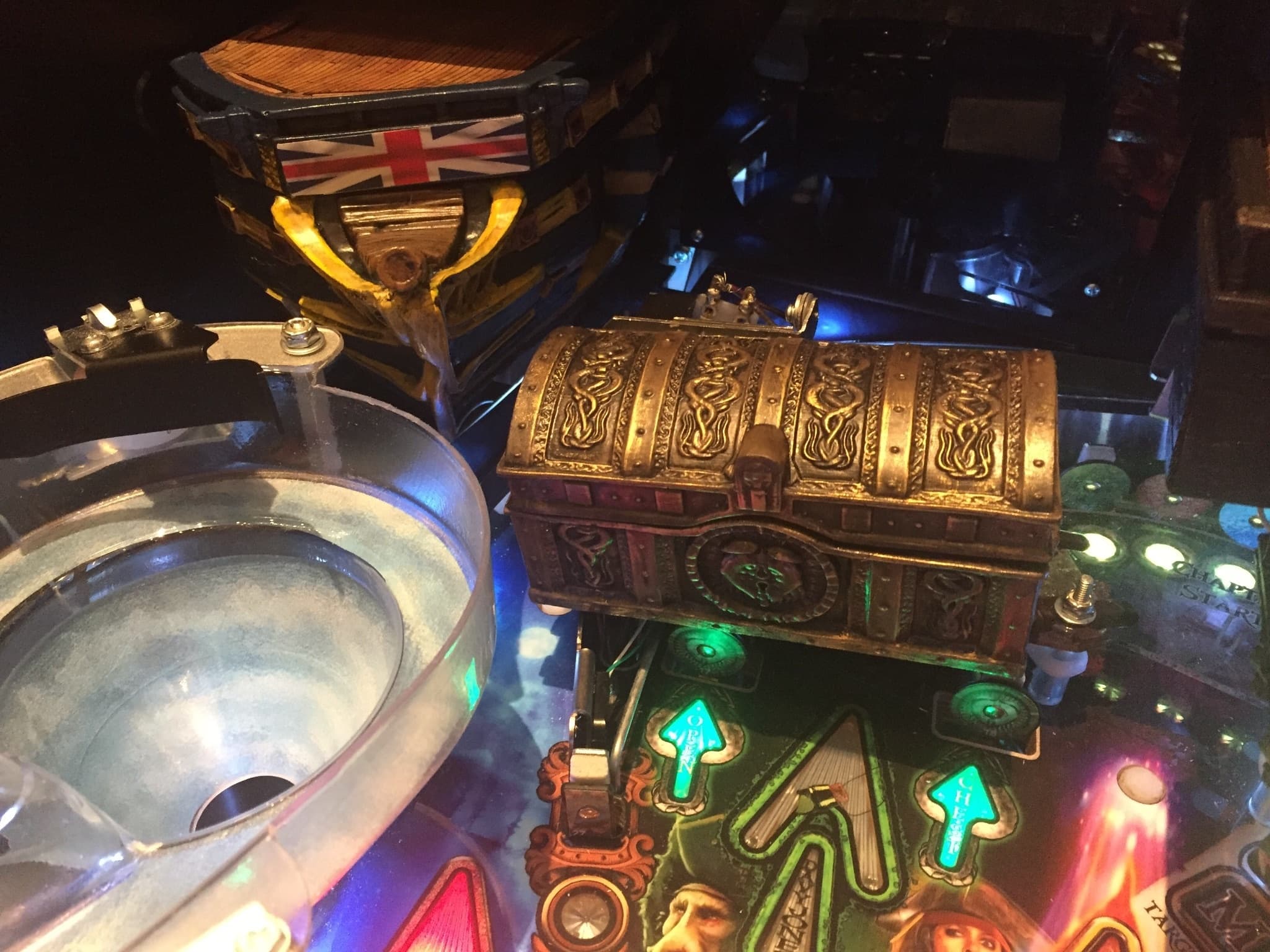 Vintage pinball machine with ornate treasure chest and colorful illuminated elements