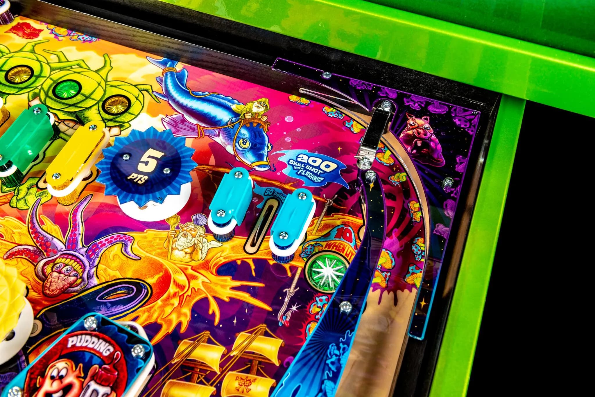 Colorful pinball machine playfield with vibrant artwork and mechanical elements