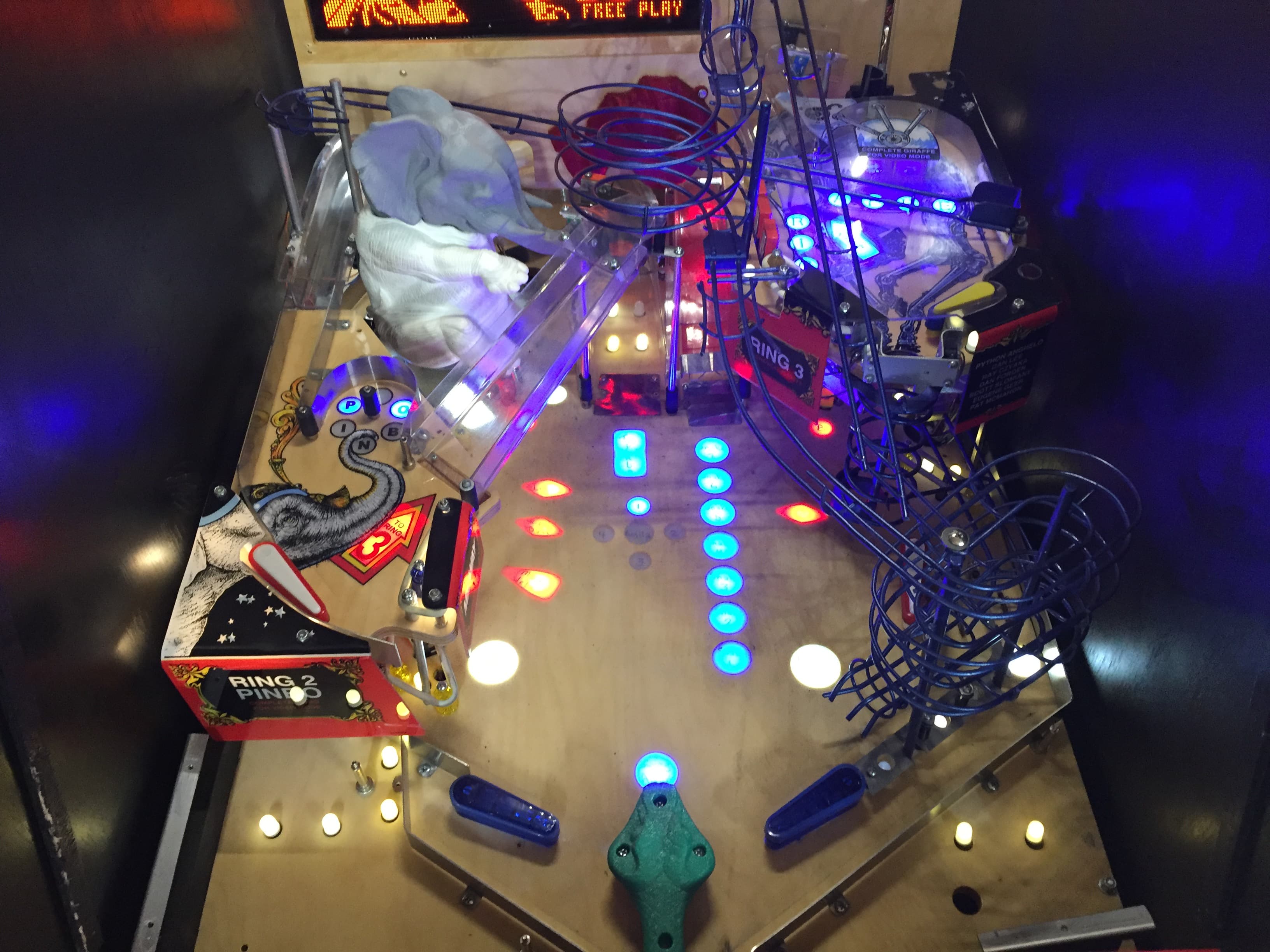 Illuminated pinball machine with colorful lights and playfield details