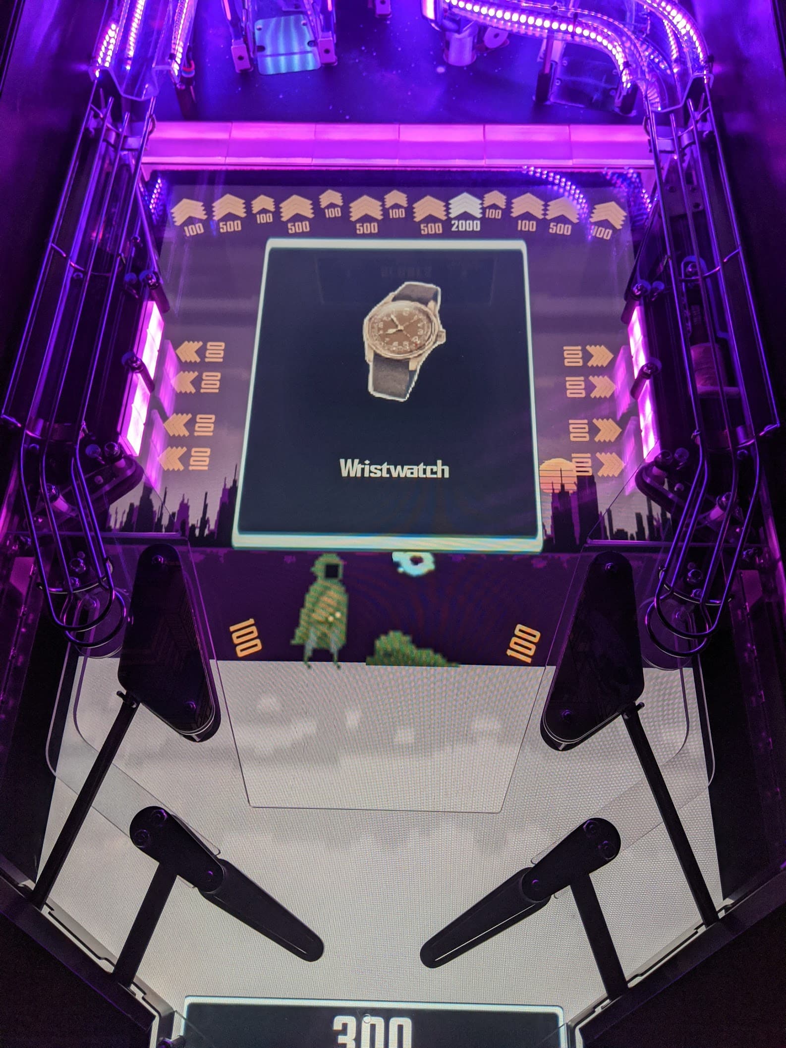Vintage wristwatch displayed on a retro pinball machine with purple lighting
