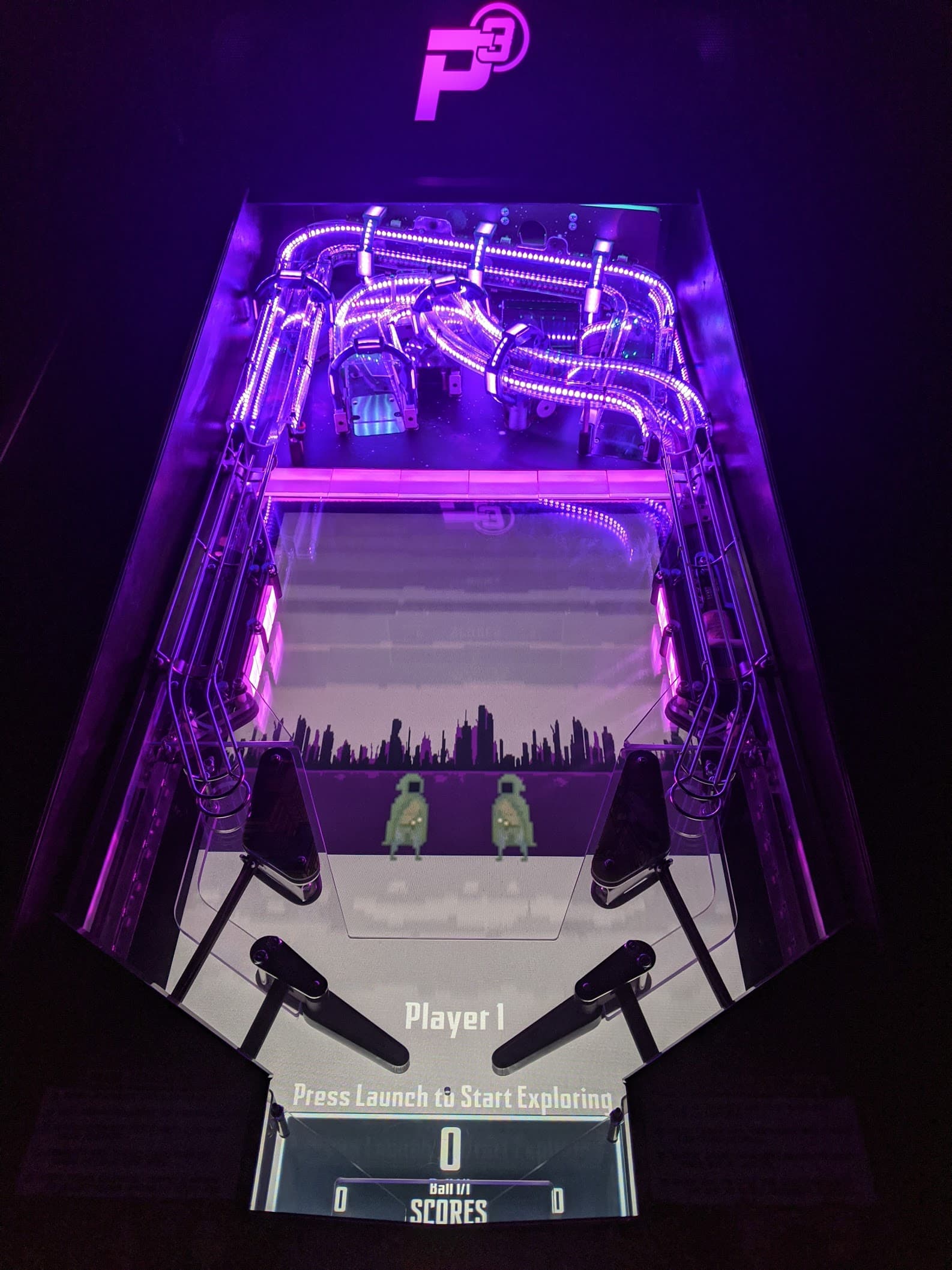 Futuristic pinball machine with purple neon lights and urban skyline backdrop