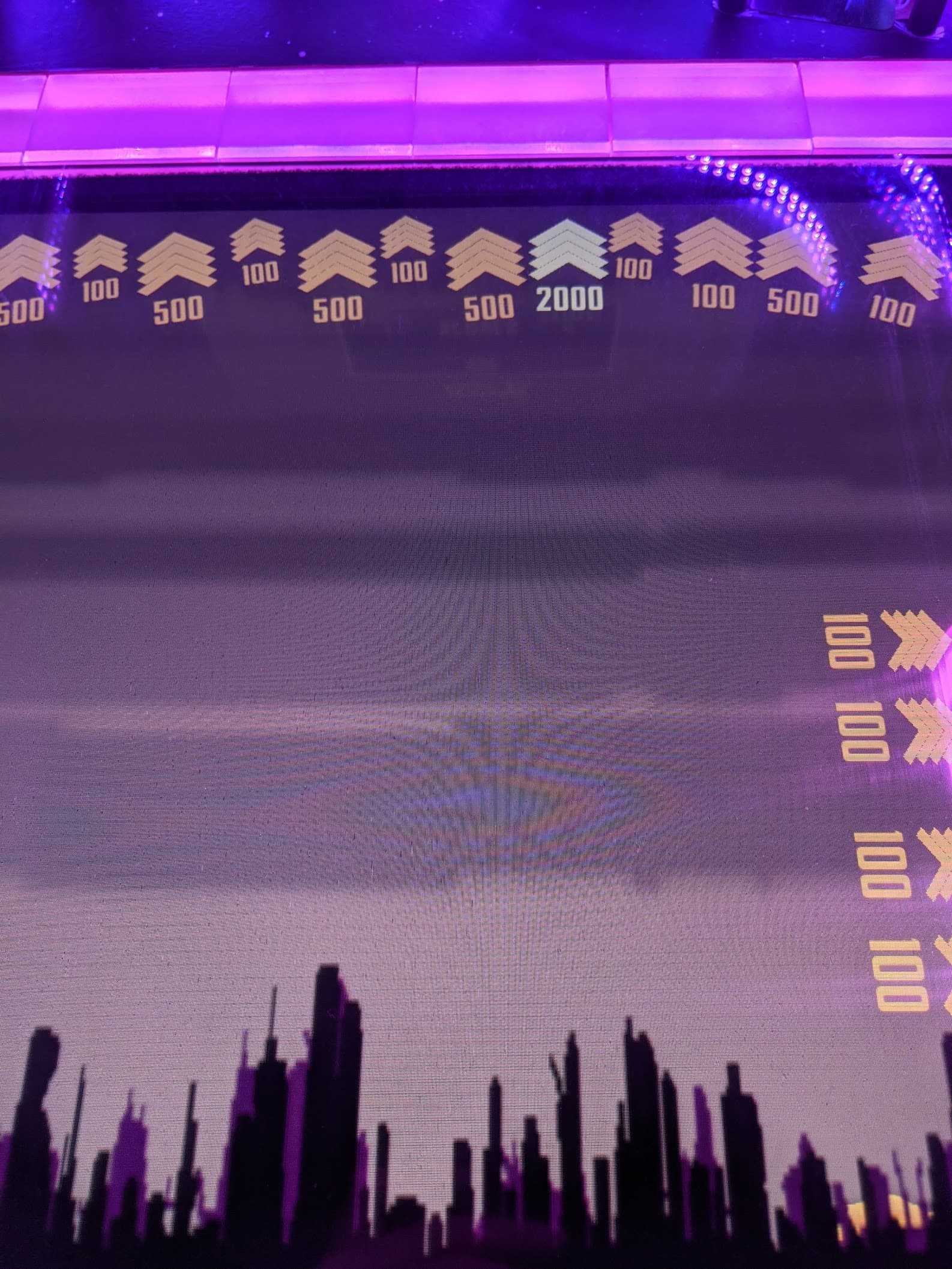 Scoreboard with city skyline silhouette in purple neon lighting