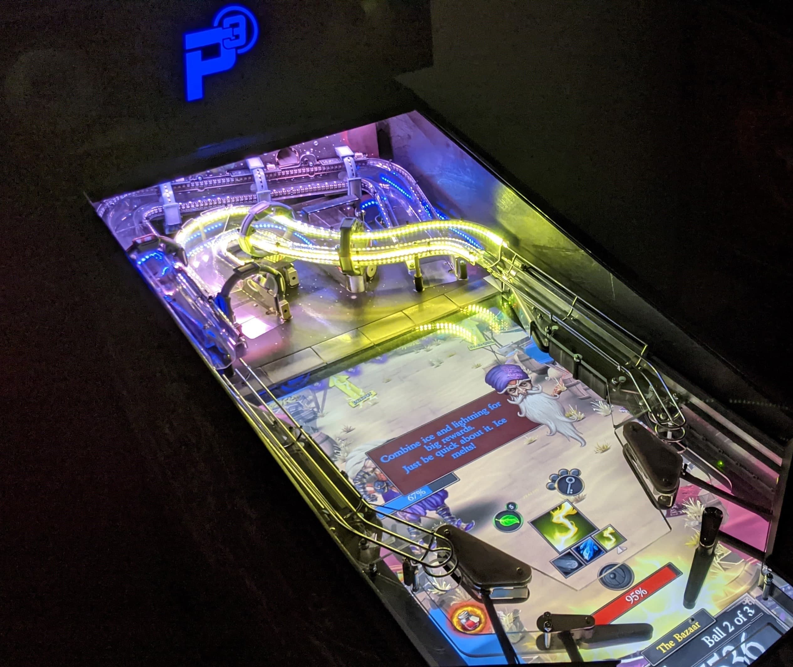 Illuminated digital pinball machine with colorful lights and complex playfield
