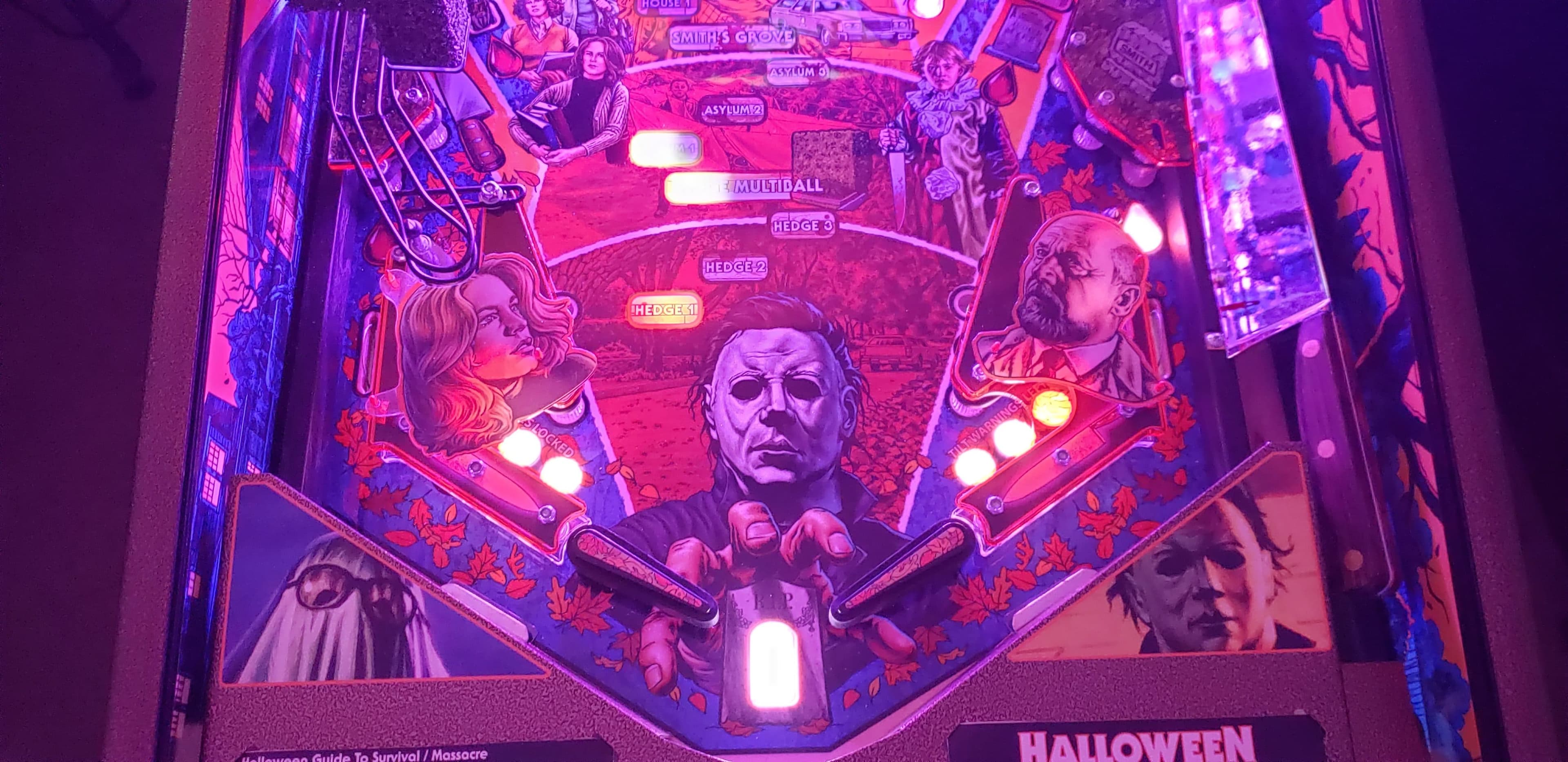 Halloween pinball machine with iconic horror characters in purple lighting