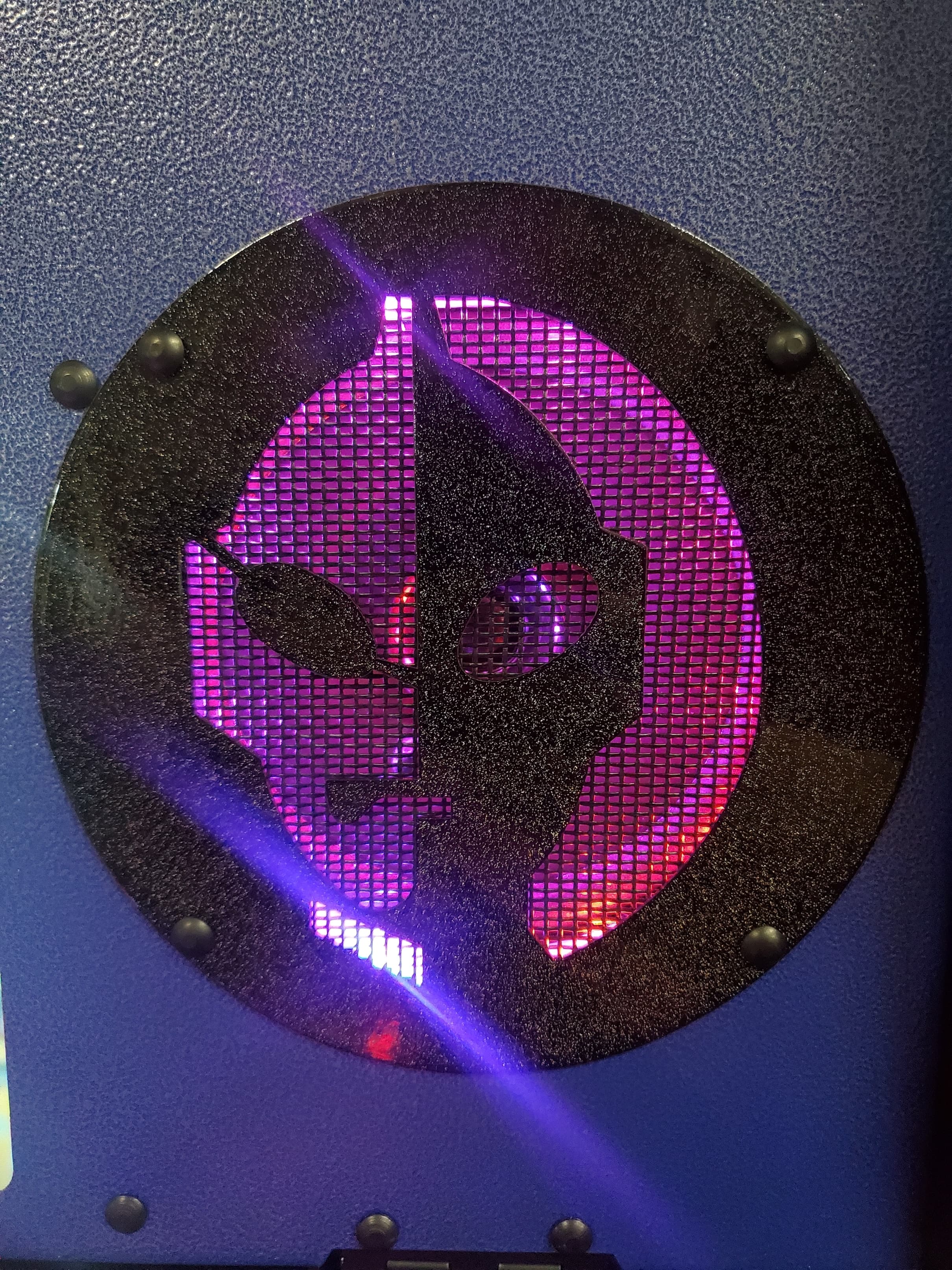 Illuminated circular panel with glowing purple mesh and abstract design
