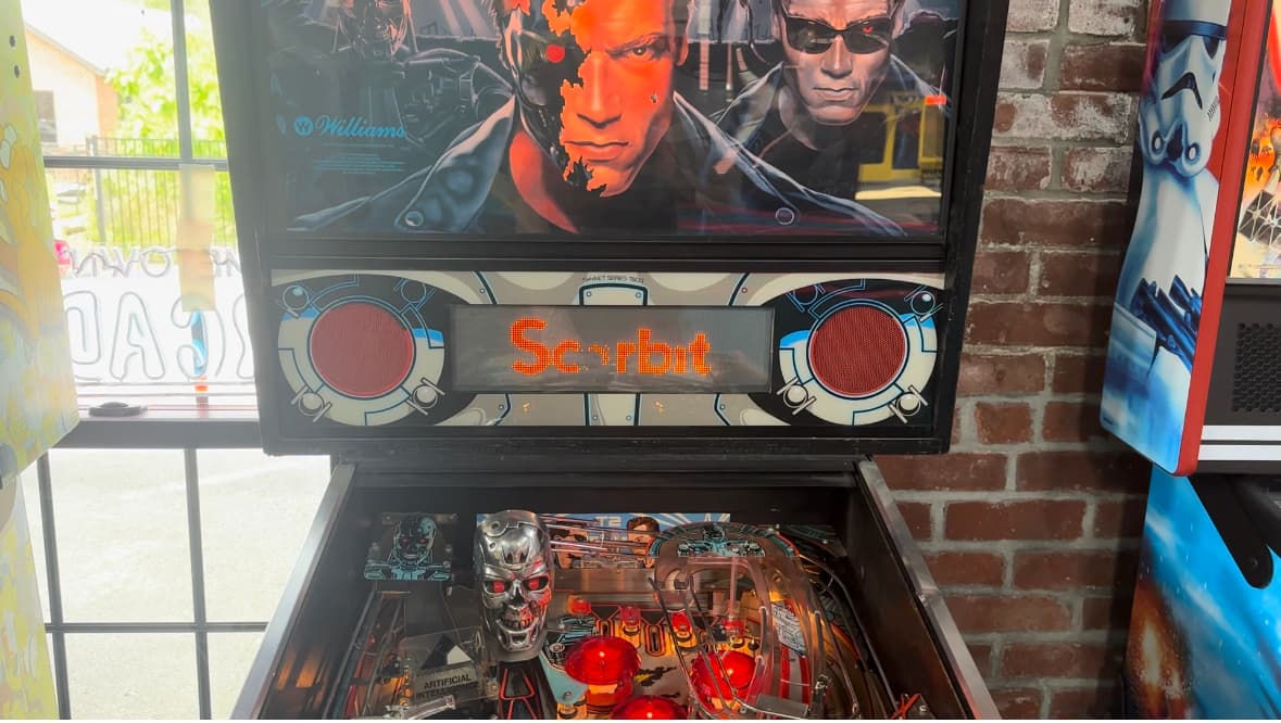 Terminator-themed pinball machine with glowing orange Scarbot display