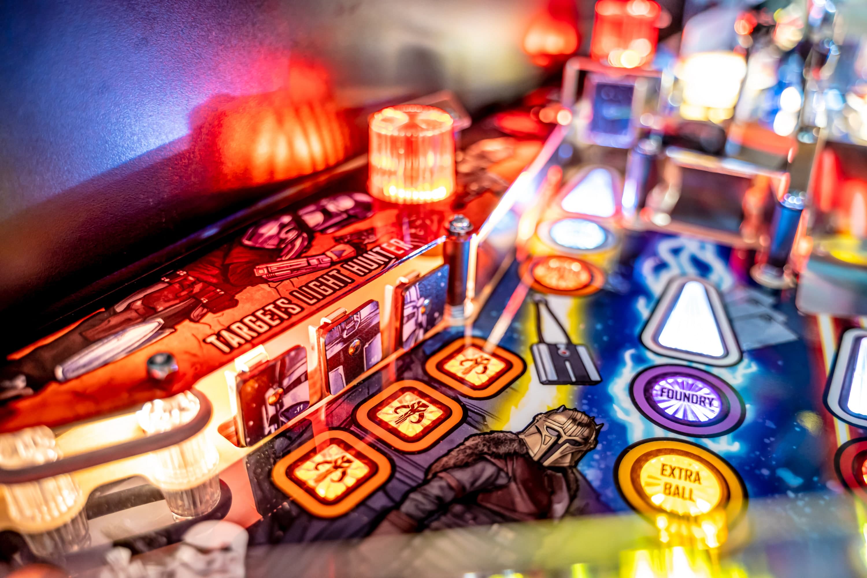Colorful pinball machine with Target Zero graphic and glowing buttons