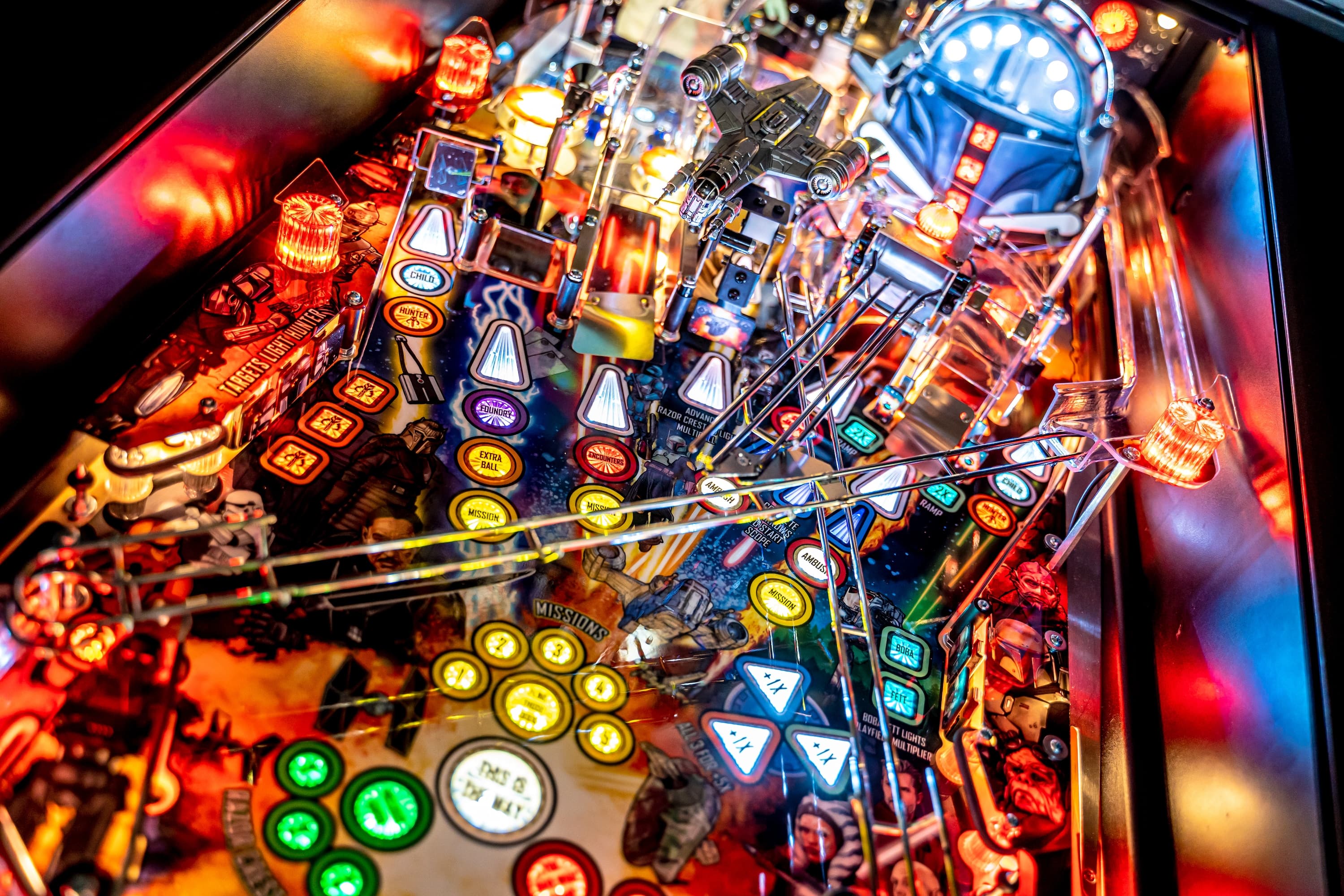 Colorful Star Wars pinball machine with glowing buttons and spaceship details